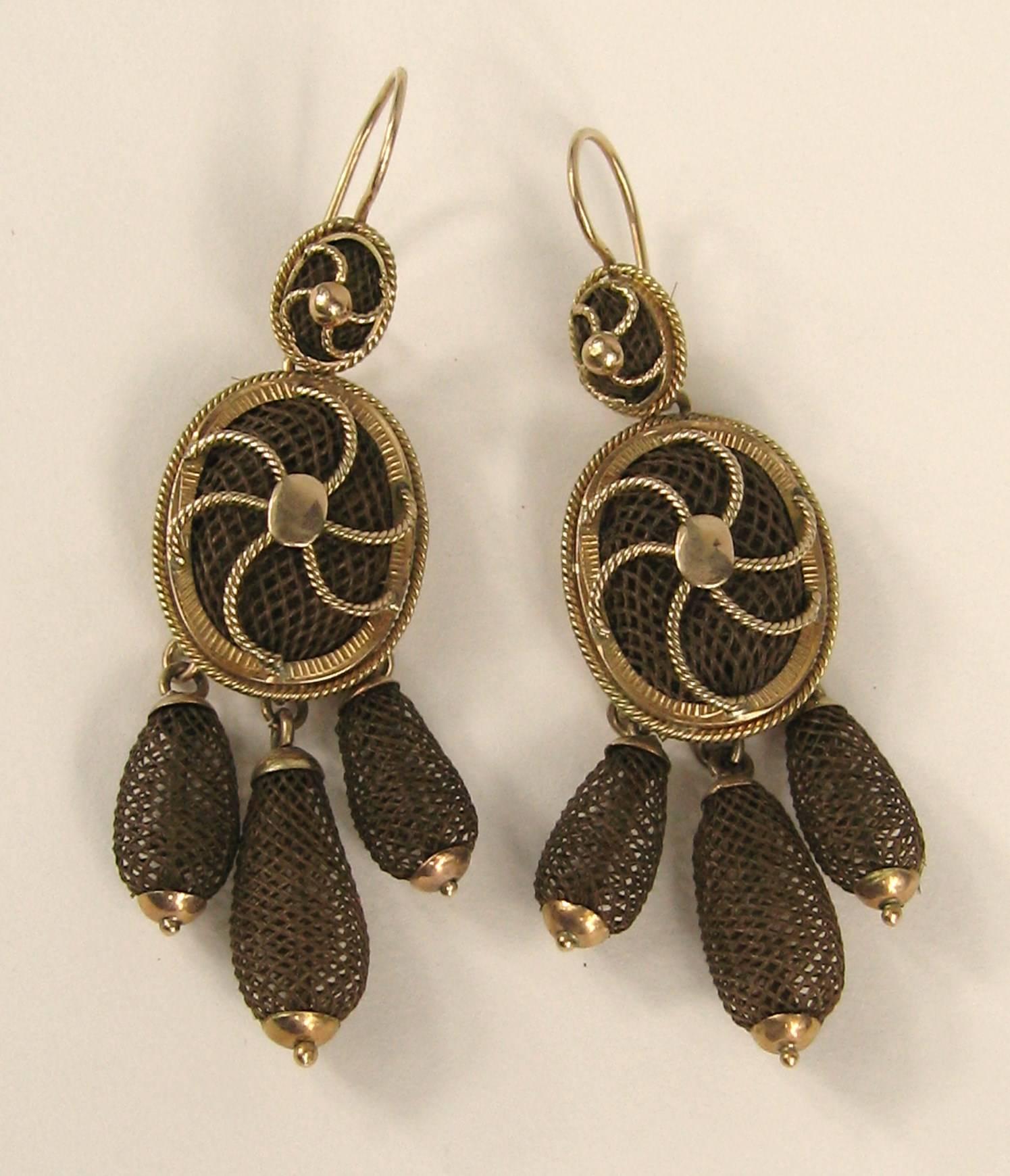 Stunning 14K Gold Victorian Mourning Earrings. Three Drop dangles That are intricately weaved human hair. They are pierced. Matching Brooch also listed on our storefront.  Measuring drops to approximate 2.33 inches x .58 inches. This is out of a