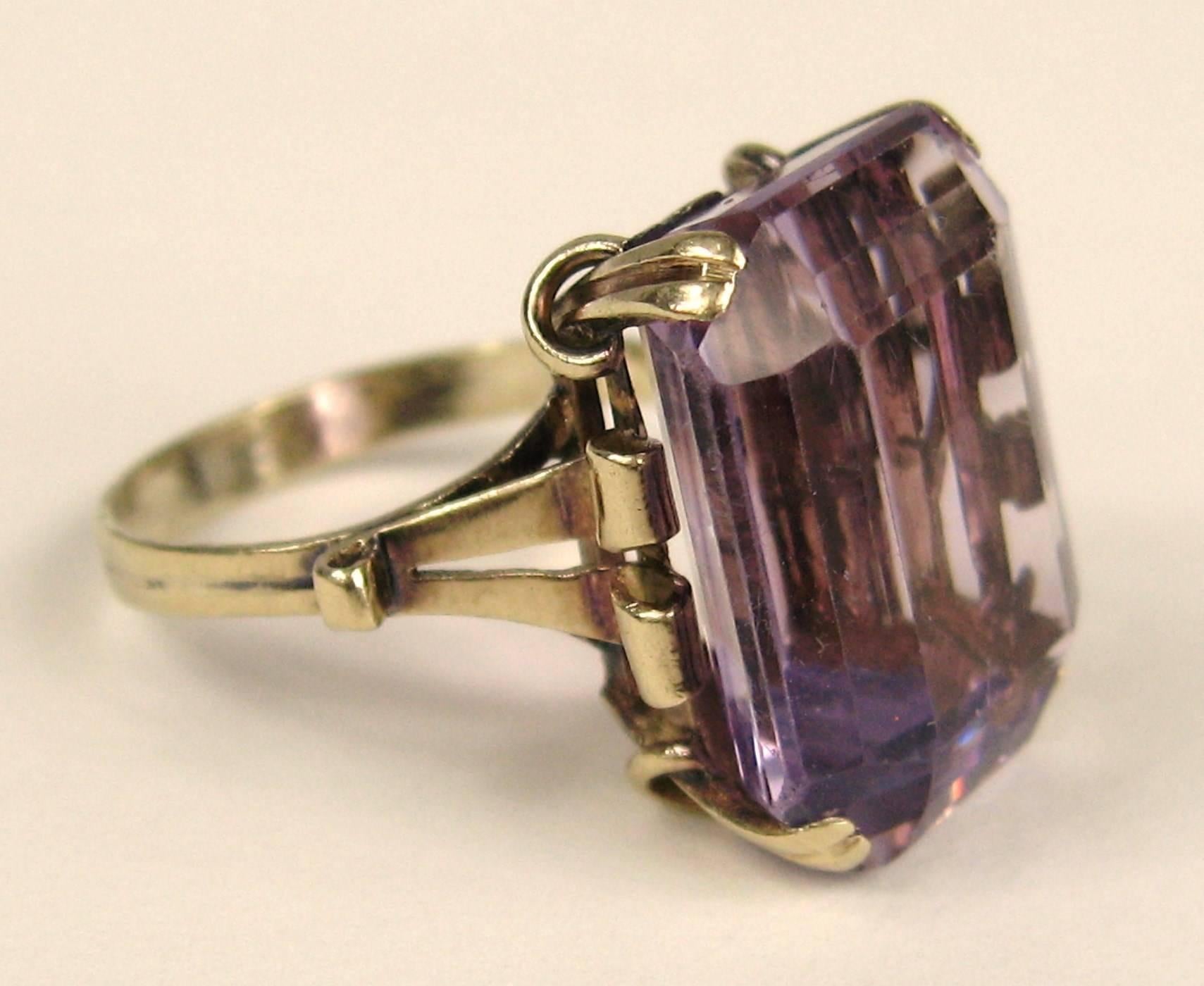 Stunning large Emerald Cut Amethyst Cocktail ring. Wonderful 14K Gold Setting on this ring. The Ring is a size 5-1/4 and can be sized by us or your jeweler, This ring sits high off the finger .37 in. Measuring .64 in top to bottom x .54 in wide. Be