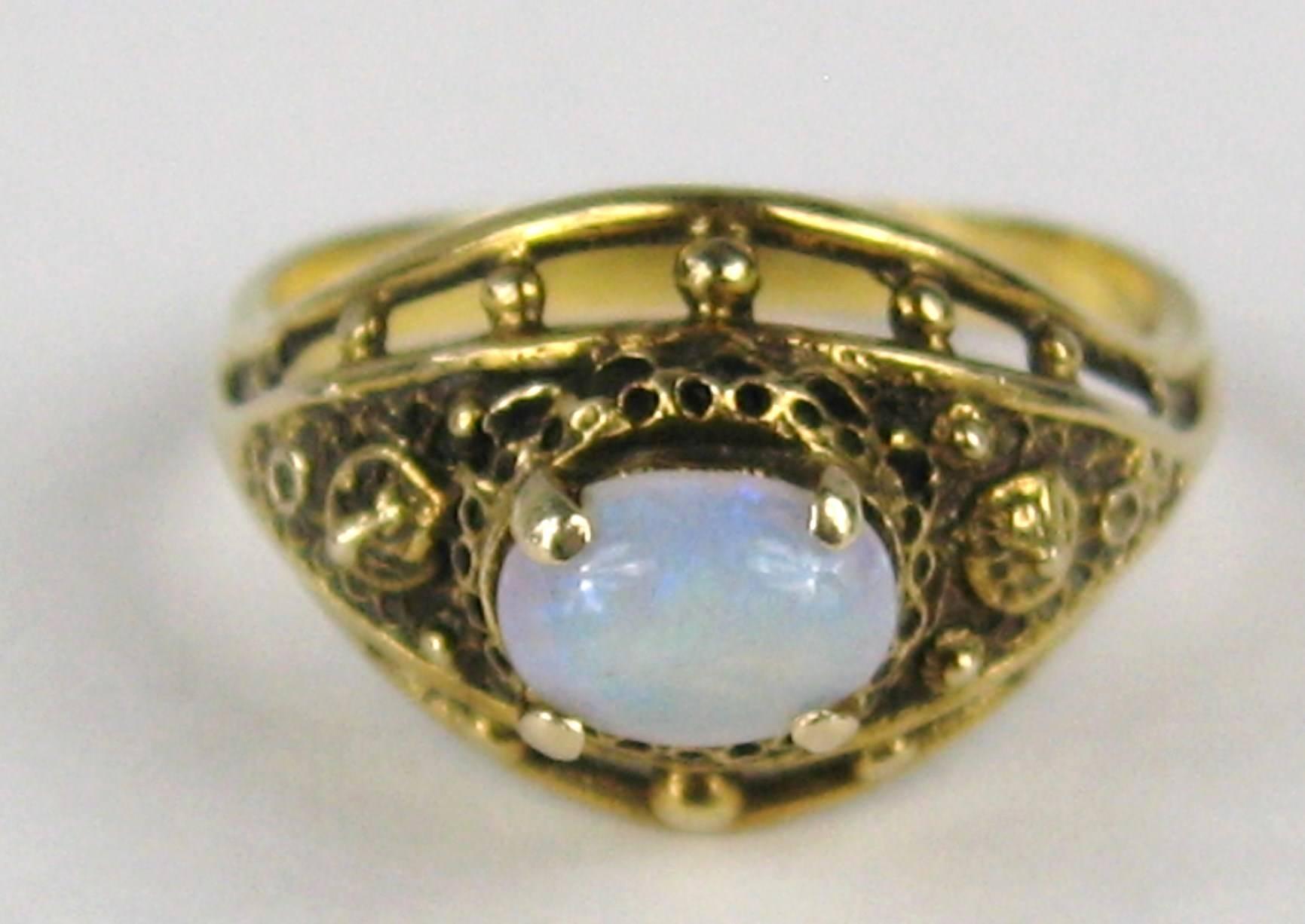 Stunning High Prong Set Opal Ring. Set in 14K Gold.  Prong set oval opal. The ring is a size 6.5 and can be sized by us or your jeweler. Please be sure to check our storefront for more jewelry as well as our huge collection of costume jewelry. We