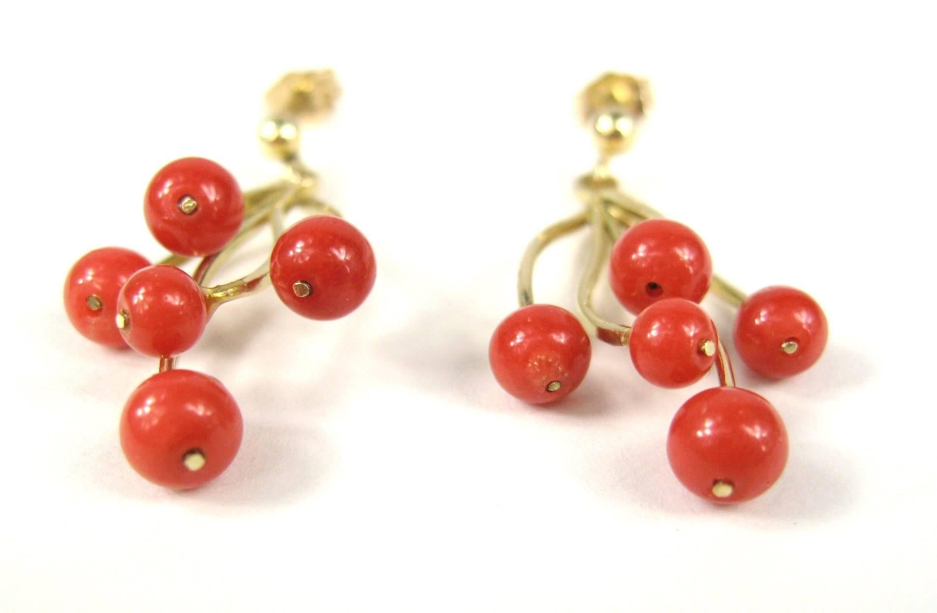 A pair of 14K gold Natural Red Coral Pierced Earrings. We have the matching necklace as well for sale. Check our store front. Coral beads attached to a Gold free form design. 
They measure 1.24 inches or 31.6 mm from top to bottom. Pierced. Coral