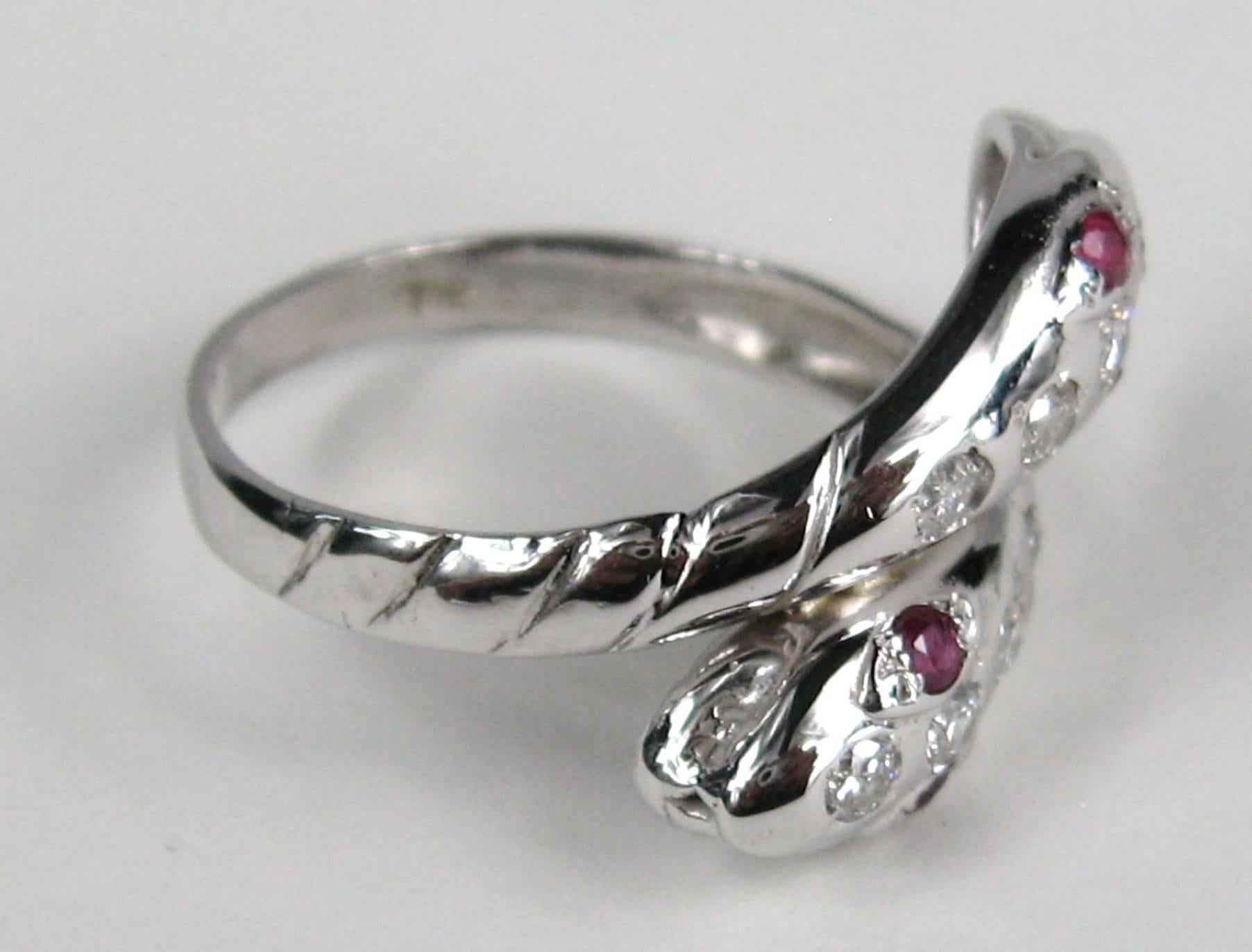 Double Headed Snake Wedding 14K Ring with 4 bezel set diamonds in each head. Rubies make up the eyes of both snakes. Ring is hallmarked inside shank. This can be worn by either a man or woman. The ring is about a 6-3/4 and can be sized by us or your