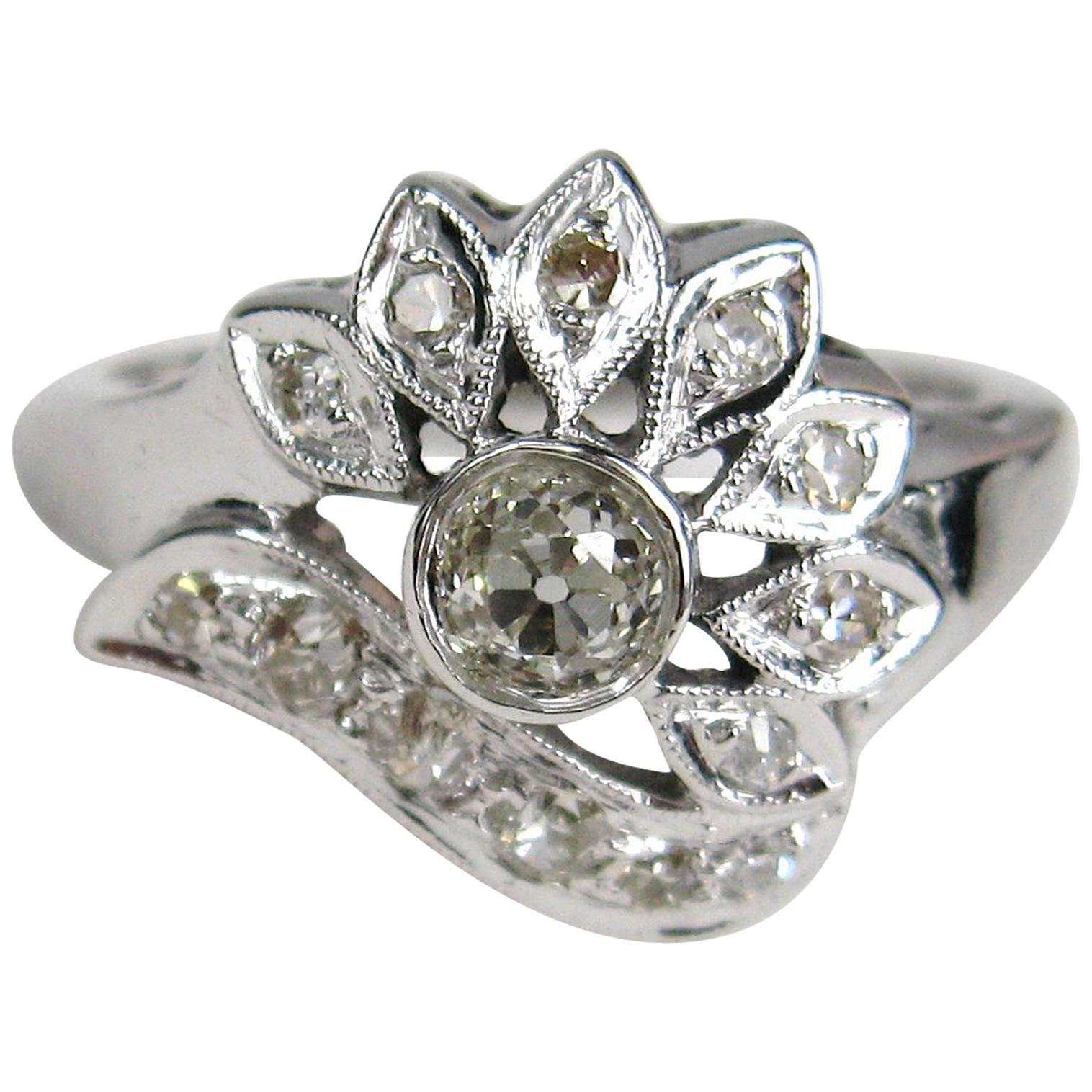 Stunning Diamond ring set in 14K White Gold. Ring, center Diamond is approximately .30 carats, I color VS clarity and 13 smaller diamond are approximately .32 carats, I/J color and SI clarity, the rind a size 7.5 and can be sized by us or your