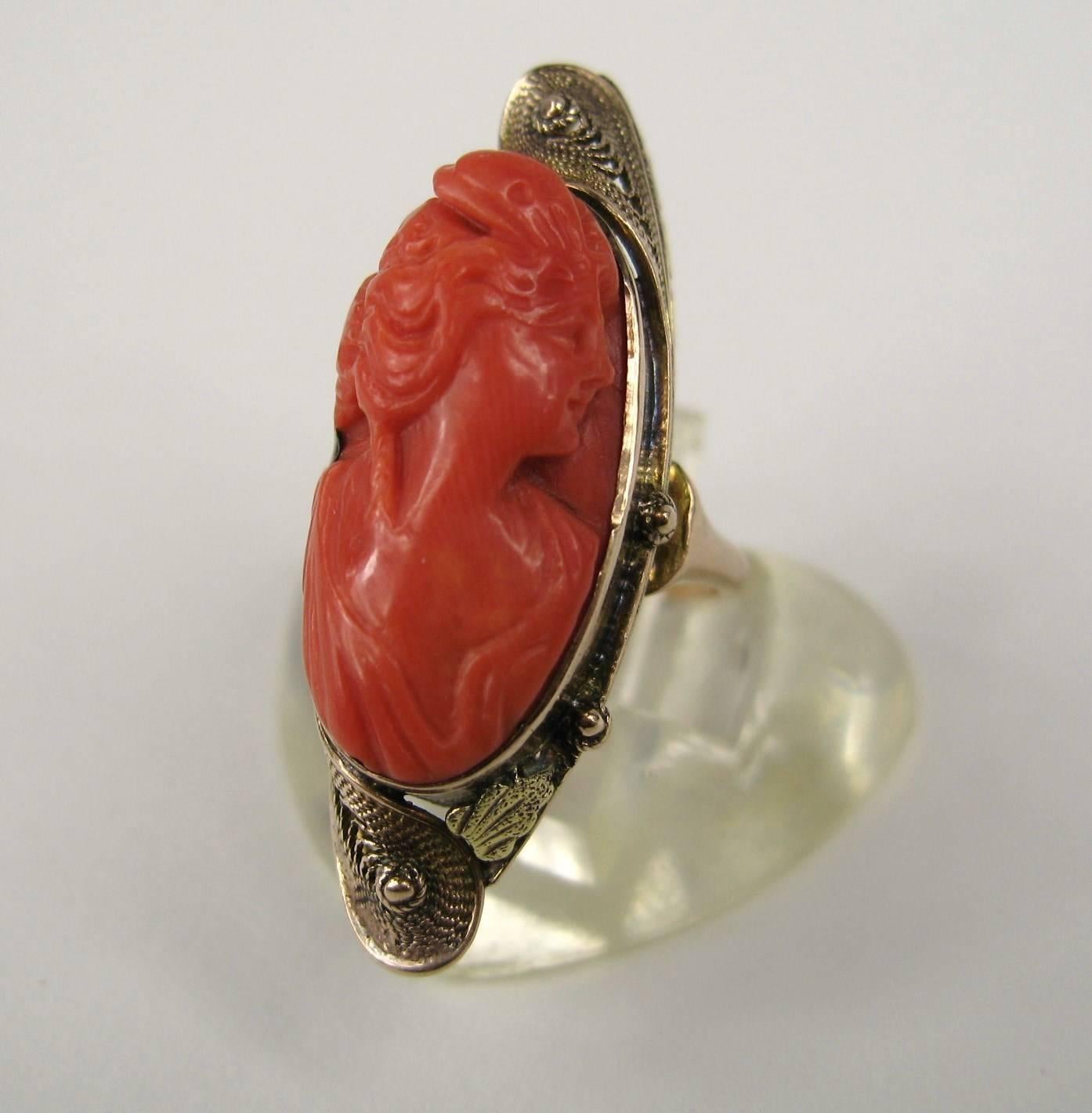 Stunning Hand Carved Coral Cameo bezel set Gold Ring. Wonderful 10K Gold Setting. Ring is a size 4 and can be sized by us or your jeweler. Ring is size Measuring 1.37 in x .50 in.  This is out of our massive collection of Hopi, Zuni, Navajo,