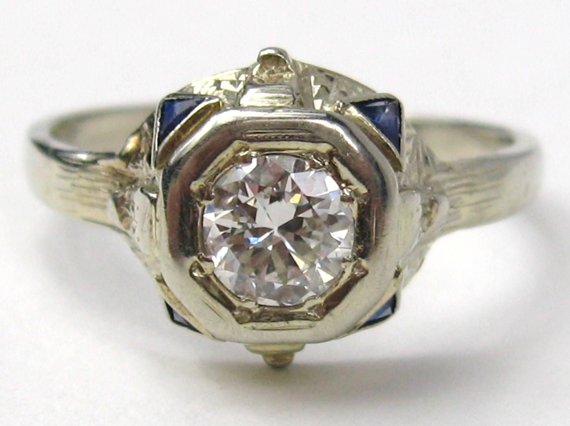 The diamond in this ring is an Old European Brilliant cut, 4 small accents. One on each corner, Set in 14K Gold. This ring is so lovely, workmanship that is hard to find in contemporary pieces. Clarity VS, G/H Color Carat .55. Ring is a size 8 and