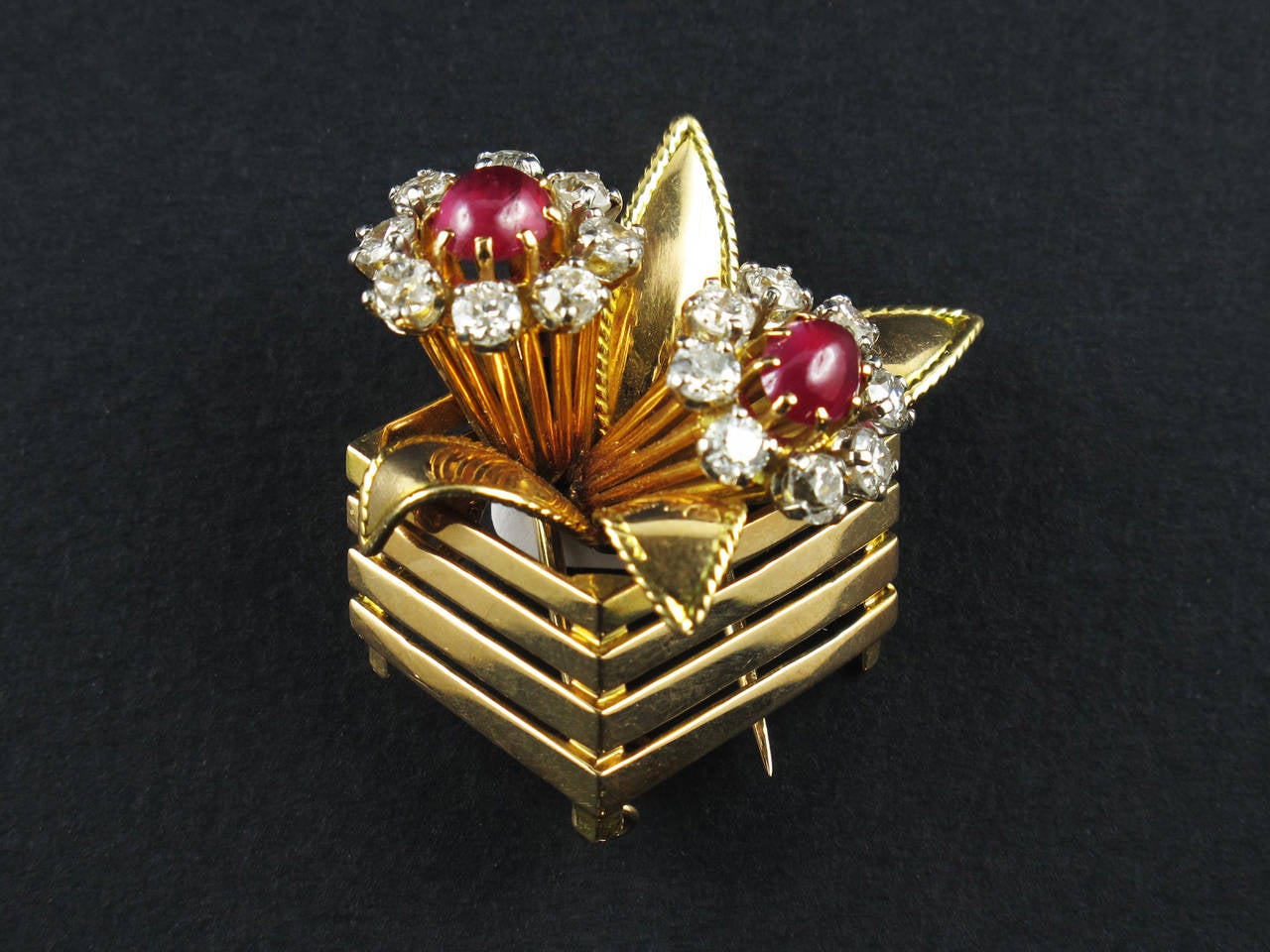 An 18 kt gold diamond and ruby basket brooch. Mauboussin, Paris, 1940 c.a.