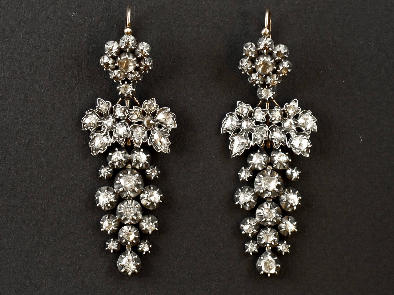 A pair of silver topped, yellow gold and rose-cut diamond ear pendents. Of vine leaf design. Day and night, the upper part can be worn without the leaves and the bunch or alone. Probably French, 1860 c.a.