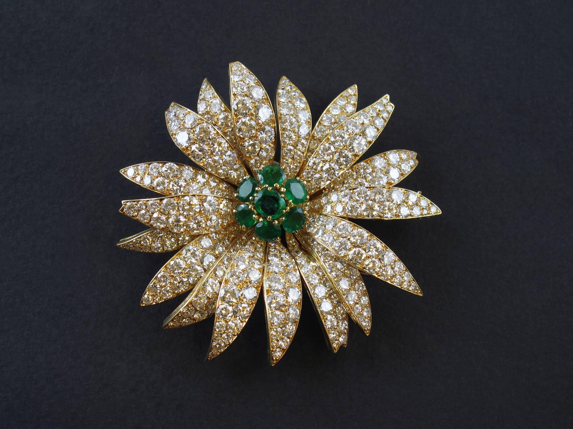 A yellow gold and diamond flower brooch centering 7 brilliant-cut emeralds. This model called Grand Marguerite has also been made for HSH Grace of Monaco in 1956. Paris, Van Cleef & Arpels
Signed, numbered and with VCA Hallmark