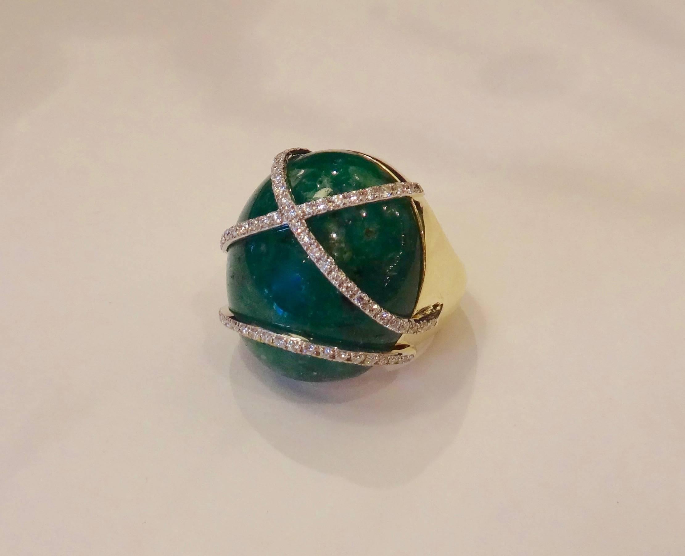 Large cabochon emerald of 46.60 carats is held in place by pave diamond straps (.68 carats total weight) in this dynamic 18k yellow gold dome ring.  Ring size 8 and to some extent is sizable.