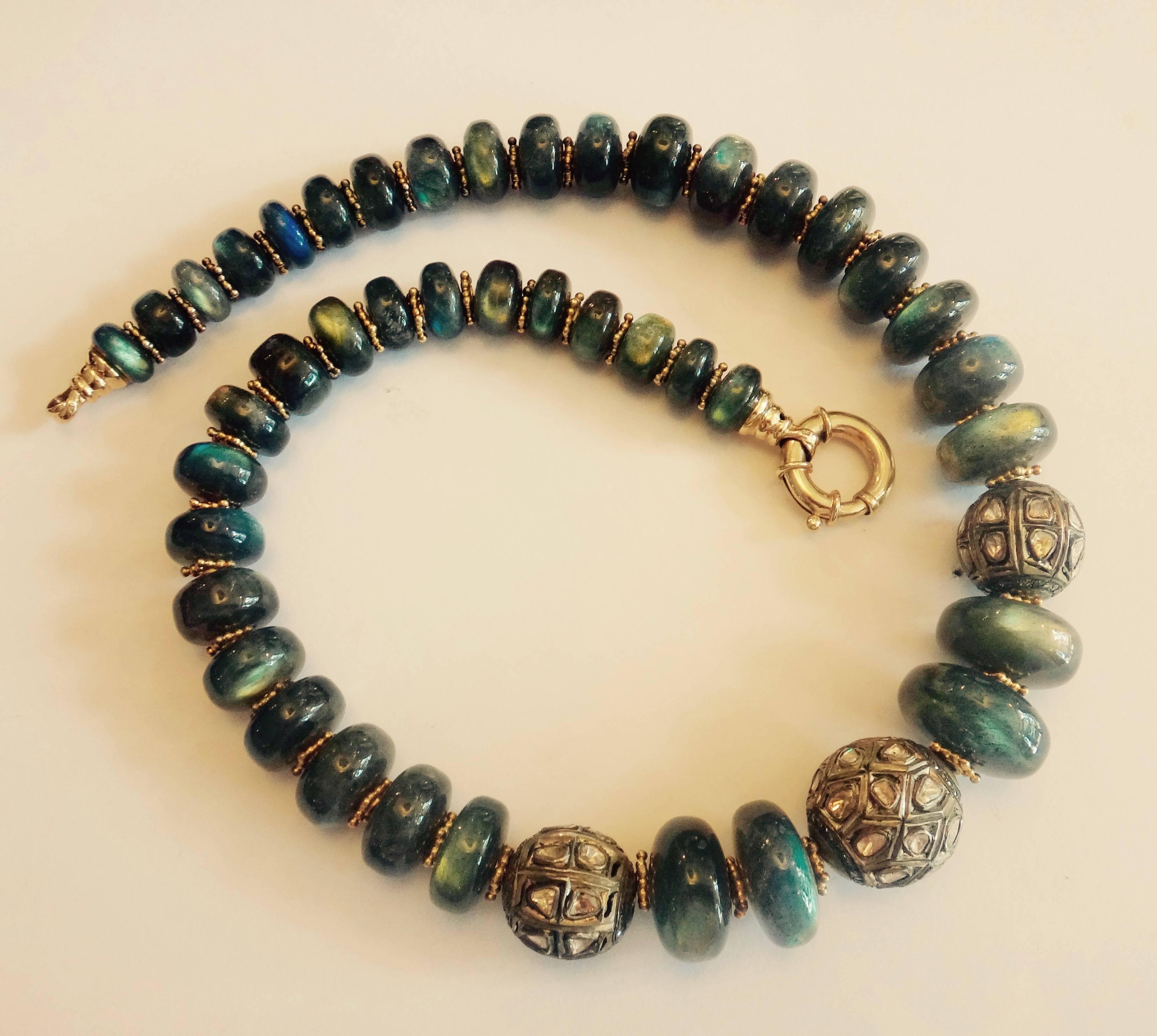 Large and flashy labradorite beads graduating from 20mm to 12mm are embellished with three silver 