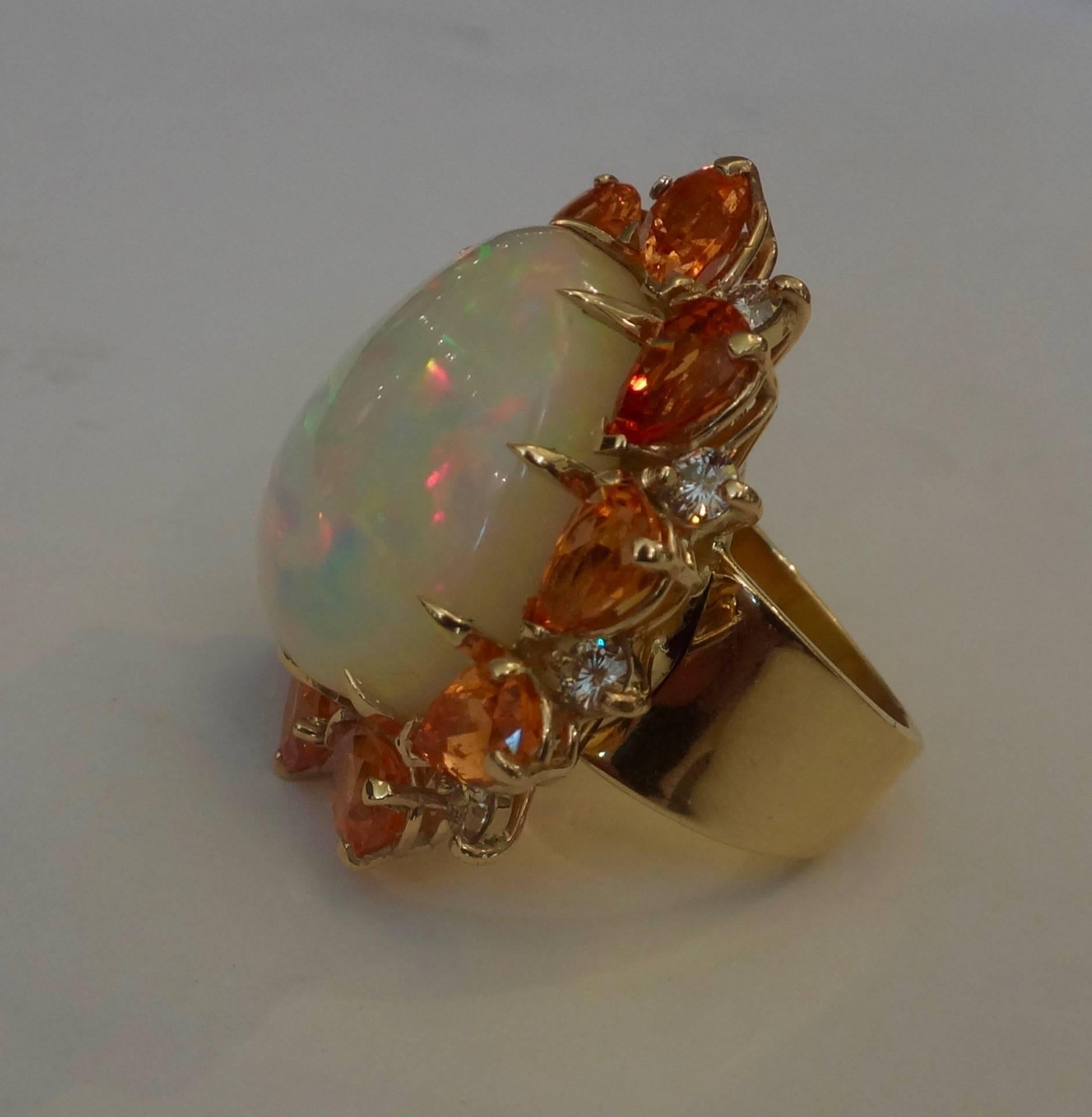 One-of-a-kind pear shaped Ethiopian opal of 25.94 carats, white crystal body with a full range of intense colors is surrounded by 10 pear shaped spessertite garnets (10 at 10.14 carats) and 10 diamonds (10 at 1.01 carats).  Hand fabricated 18k