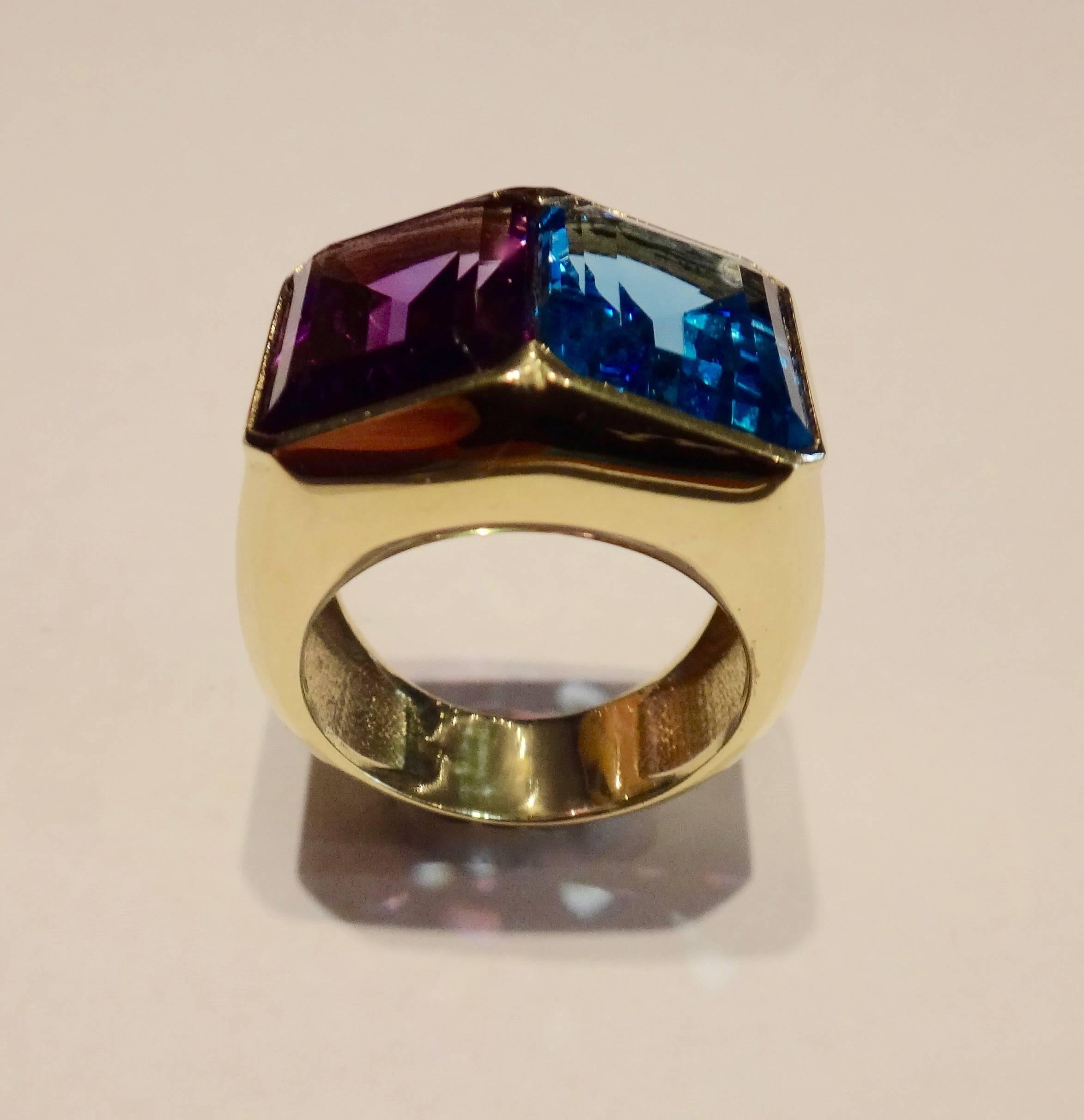 Perfectly matched and highly complimentary in color are these emerald cut London blue topaz and Deep purple amethyst set in a carefully crafted 18k yellow gold cocktail ring.  Ring size 7 and may to some degree be sized.  