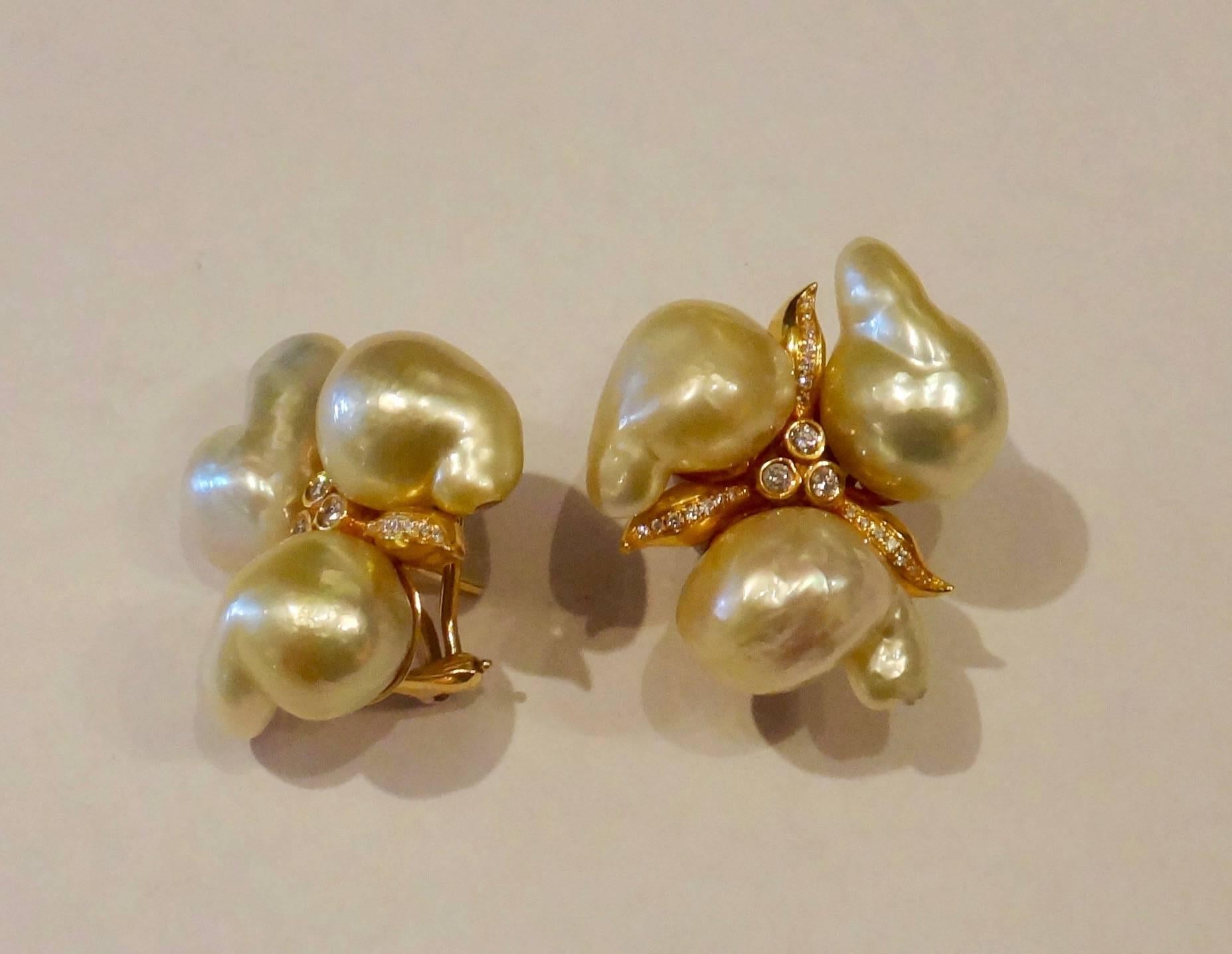 Very baroque Maluka pearls (Origin: Borneo) are combined with bezel set and pave set diamonds in these bold, one-of-a-kind cluster earrings.  The pearls have lovely shades and tones of white, gray and gold and possess great luster.  The earrings