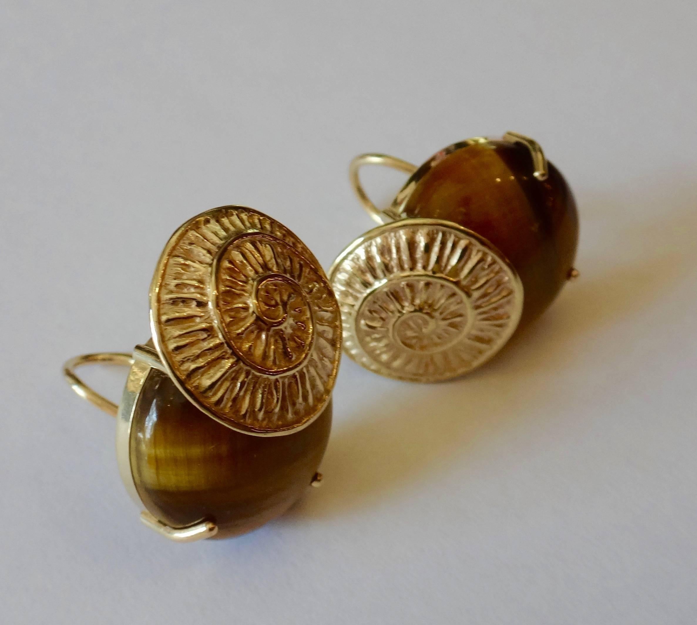 20mm round golden tiger's eyes with a wonderful silky luster are set in 14k yellow gold spiral button earrings.  The handmade earrings come with posts with omega clip backs for comfort and safety.  