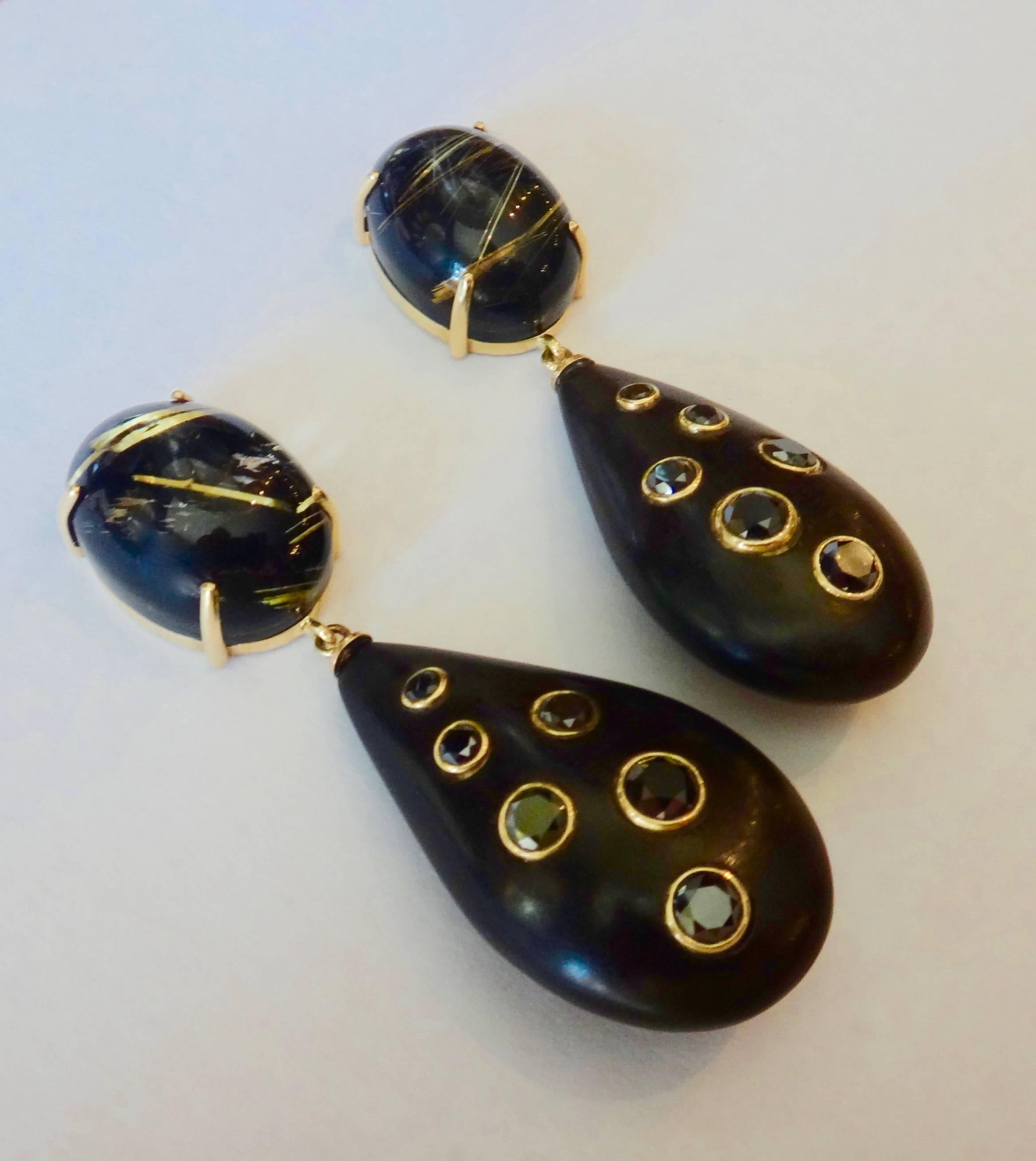 Dangle earrings composed of carved ebony embellished with twelve black diamonds and suspended from highly unusual black jade backed rutilated quartz. The backing really makes the golden rutile 