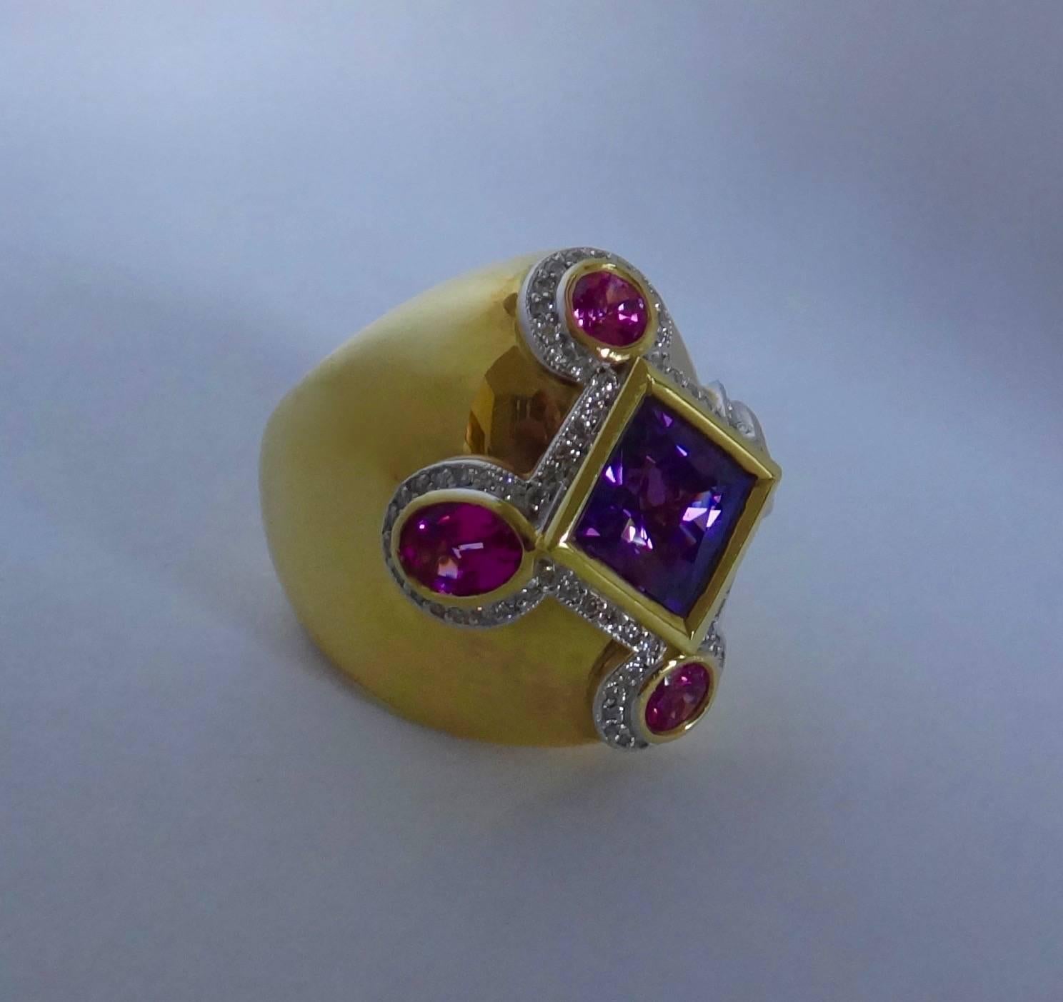 This one-of-a-kind dome ring showcases a square cut purple spinel flanked by round and oval cut pink spinels (Origin: Sri Lanka).  Highlighting the five gems is a frame of pave set, brillant cut white diamonds.  The hand crafted, highly polished 18k