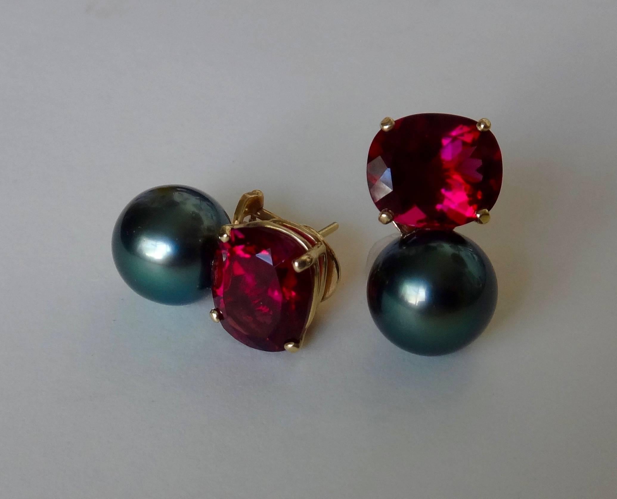 Intensely colored and perfectly matched 10 x 12 mm cushion cut rubelite (red) tourmalines are enhanced with gem quality (nearly black) 12mm Tahitian pearls.  Posts with omega clip backs.  