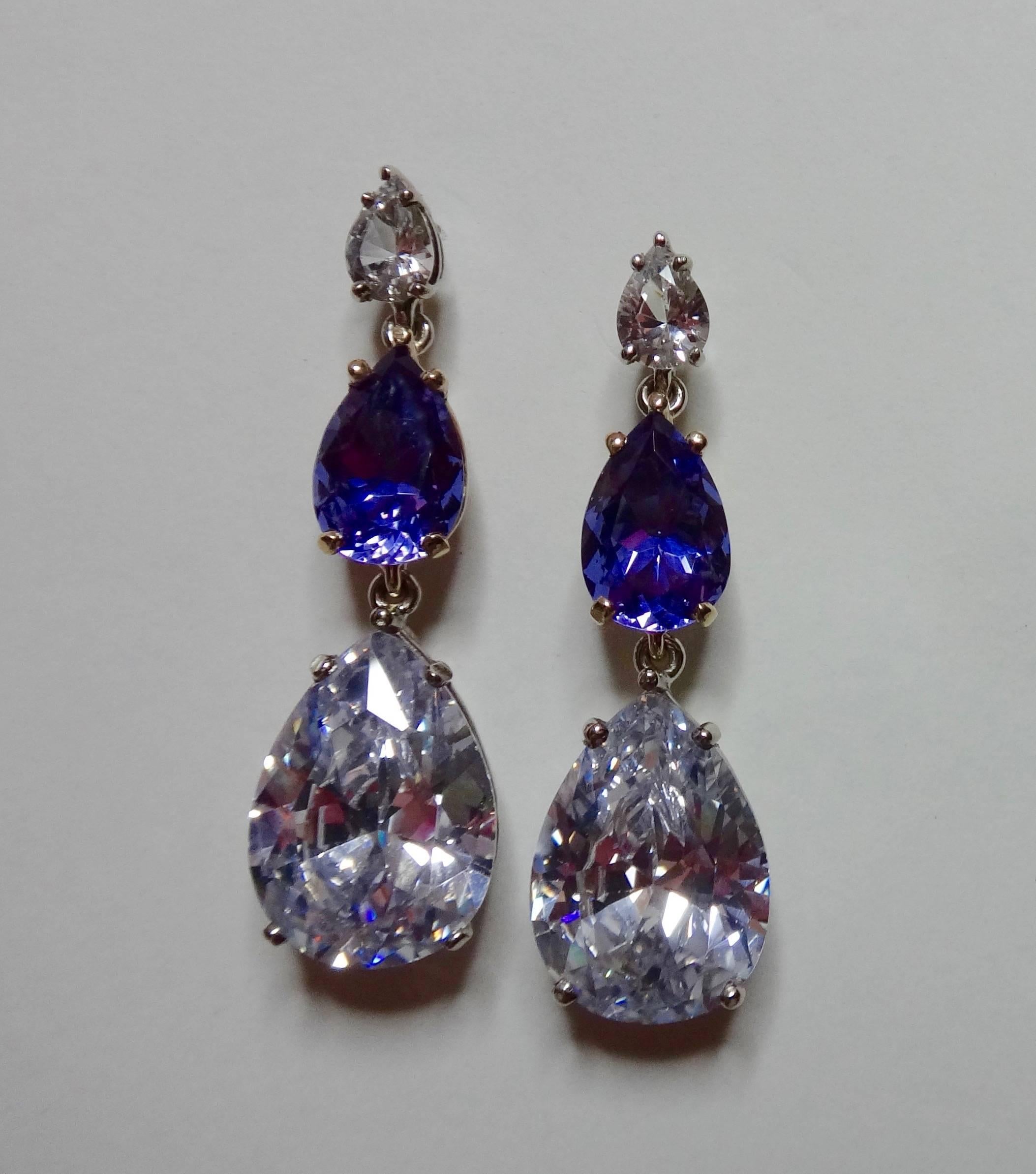 Three pear shaped gems consisting of silver sapphire, color change zultanite (mineral diaspore found in the Ilbir Mountains of southwest Turkey) and platinum topaz create these dangle earrings.  All set in two tone, handmade settings.  Post with