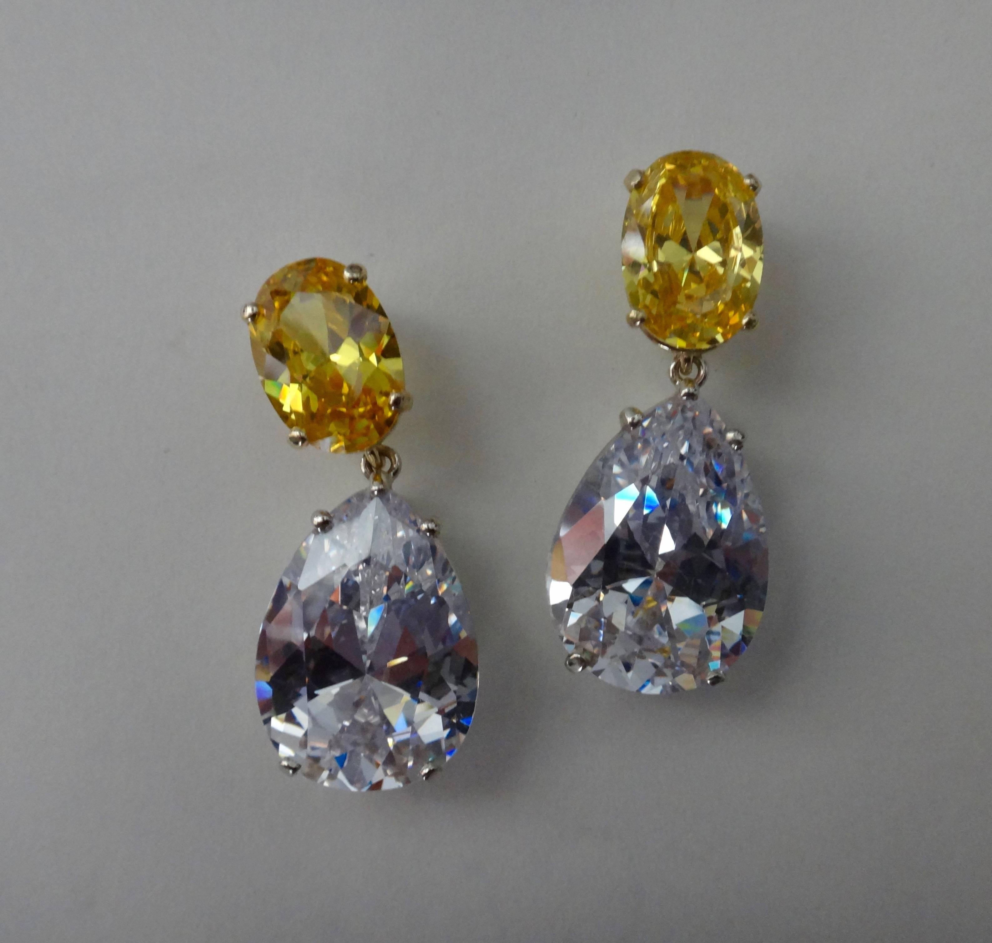 Exceptionally well cut oval golden zircons (Origin: Myanmar) are paired with equally well cut, pear shaped platinum topaz (Origin: Brazil) in these dramatic, sparkling drop earrings.  Zircons come in many colors including blue, green, brownish red,