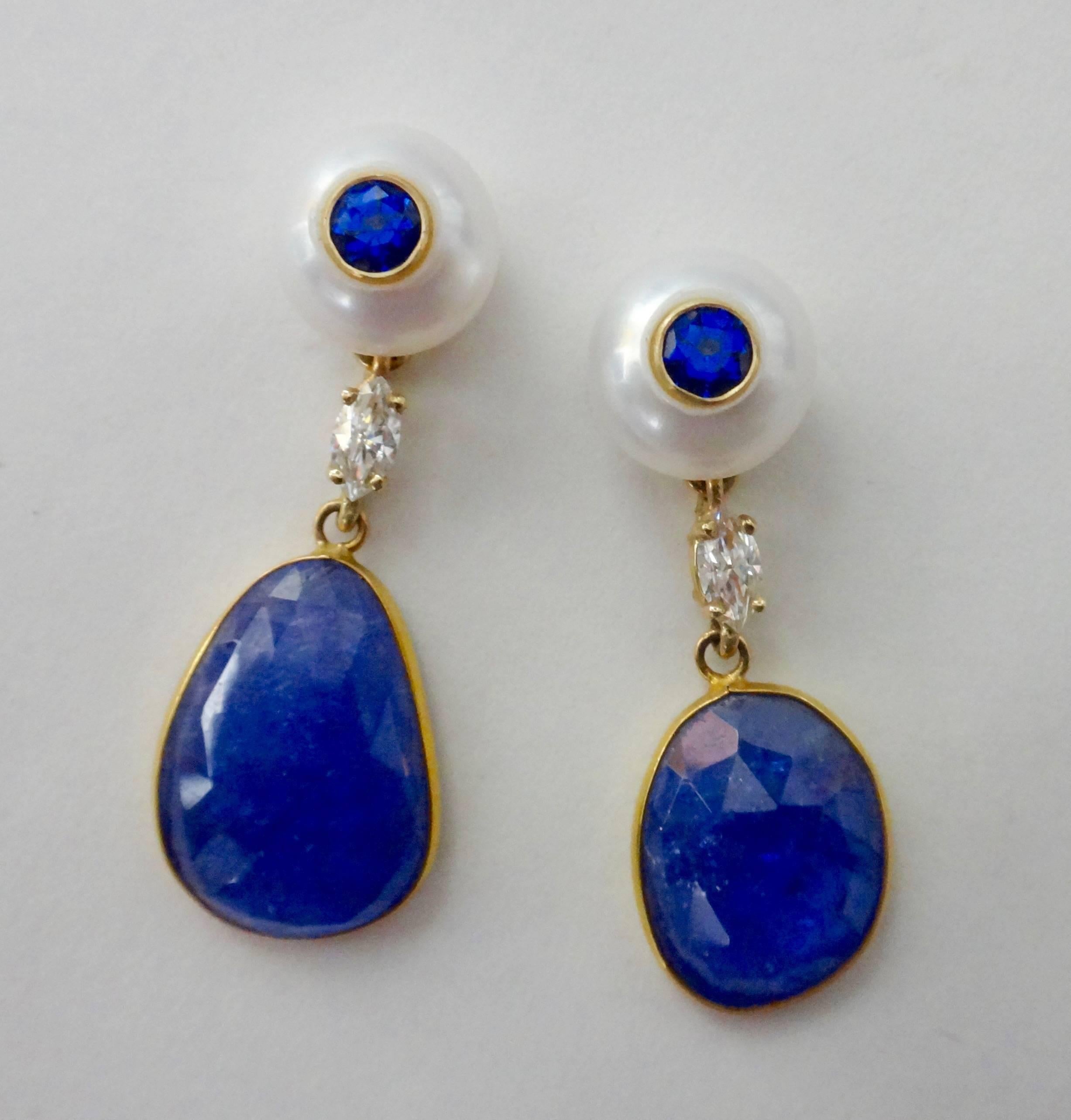 Checkerboard faceted and freeform shaped Tanzanite slices dangle from marquise cut diamonds and button pearls decorated with bezel set blue sapphires.  All set in 18k yellow gold with posts and jumbo friction backs.  