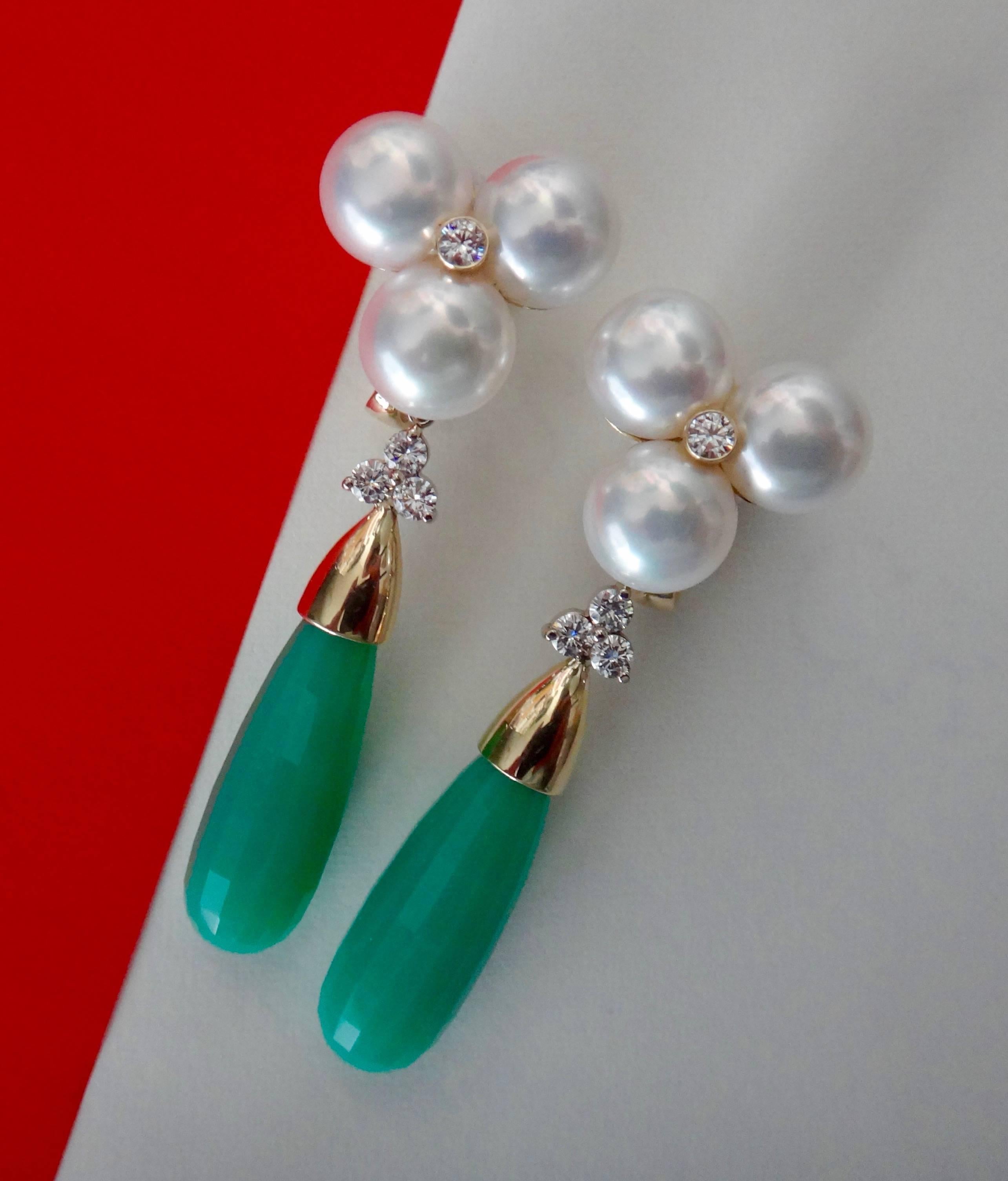 A cluster of three white pearls decorated with bezel set diamonds are the foundation for a large and long pair of faceted chrysoprase briolette drops.  The diamond and briolette drops are removalbe making these very versatile earrings.  All set in