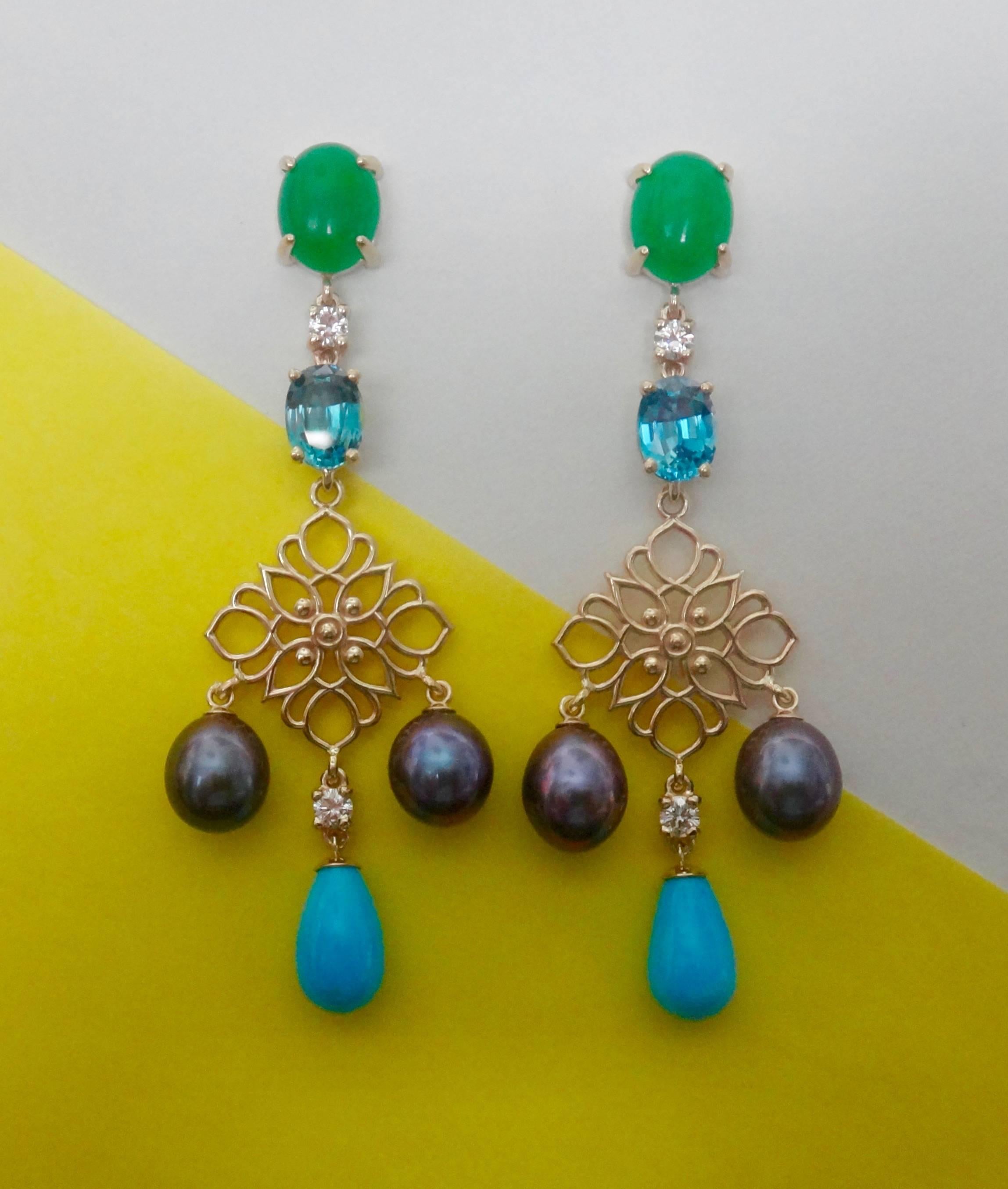 A pair of brilliant, apple green chrysoprase are combined with oval, faceted blue zircons (Origin: Sri Lanka) , brilliant cut white diamonds, black cultured pearls and Sleeping Beauty turquoise drops in these dramatic filigree dangle earrings. 