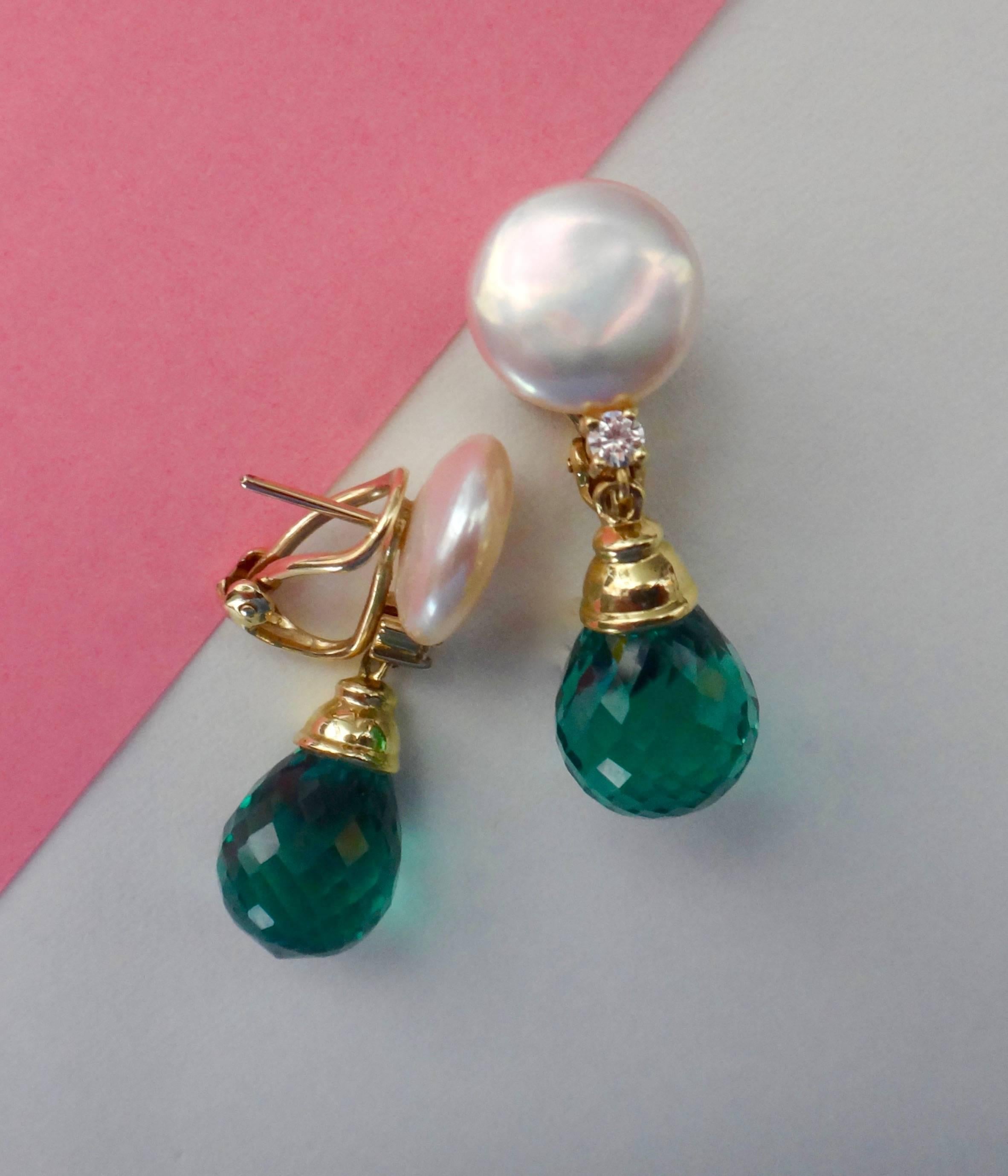 White coin pearls with a bright and lustrous finish are enhanced with brilliant cut white diamonds and forrest green amethyst briolette in these 