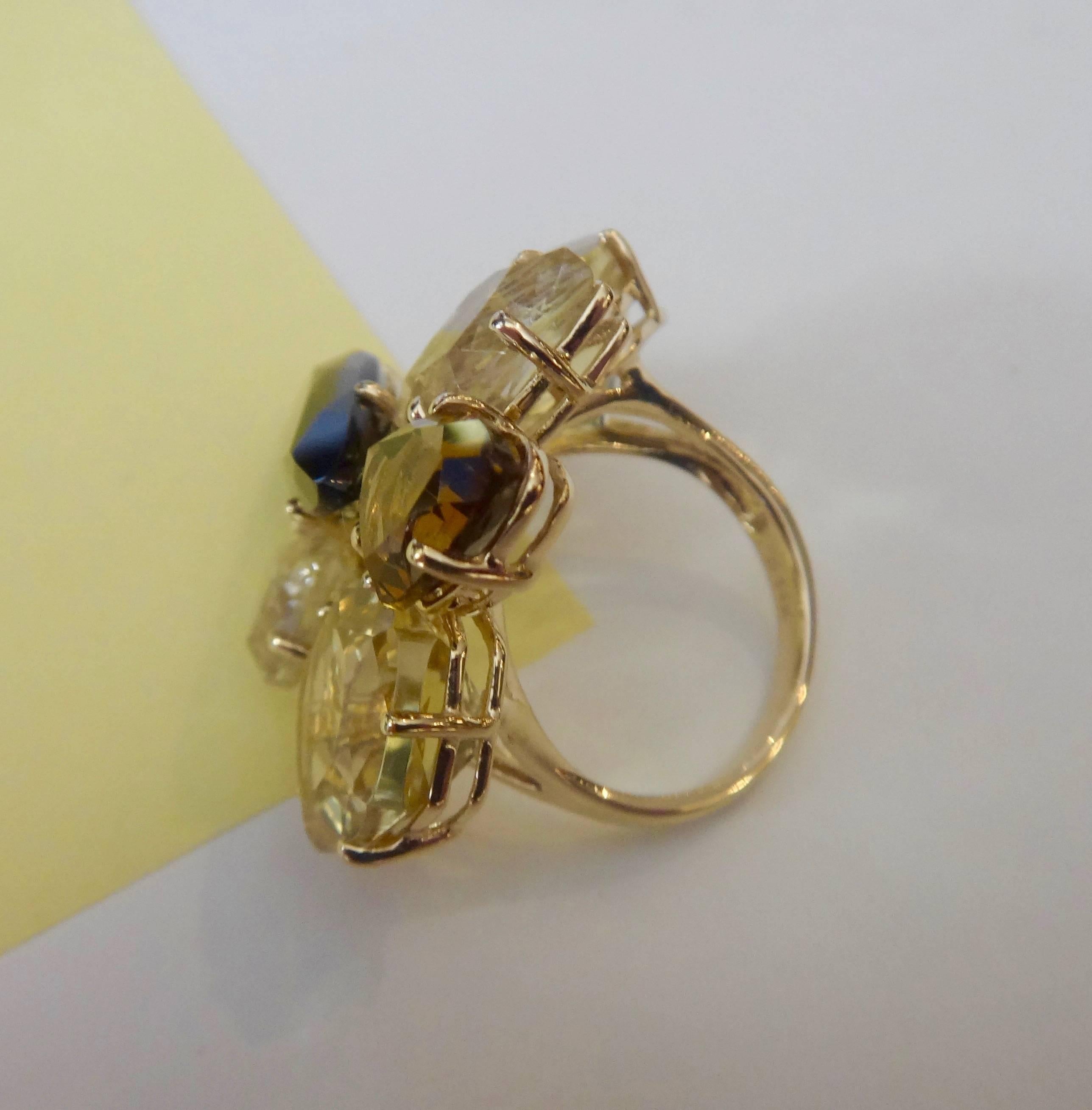 Autumnal colors of yellows and browns in six free form shaped gems of lemon citrine, rutilated and smokey quartz are clustered together in this dramatic cocktail ring.  All prong set in 14k yellow gold.  Ring size 7 and may be easily sized.