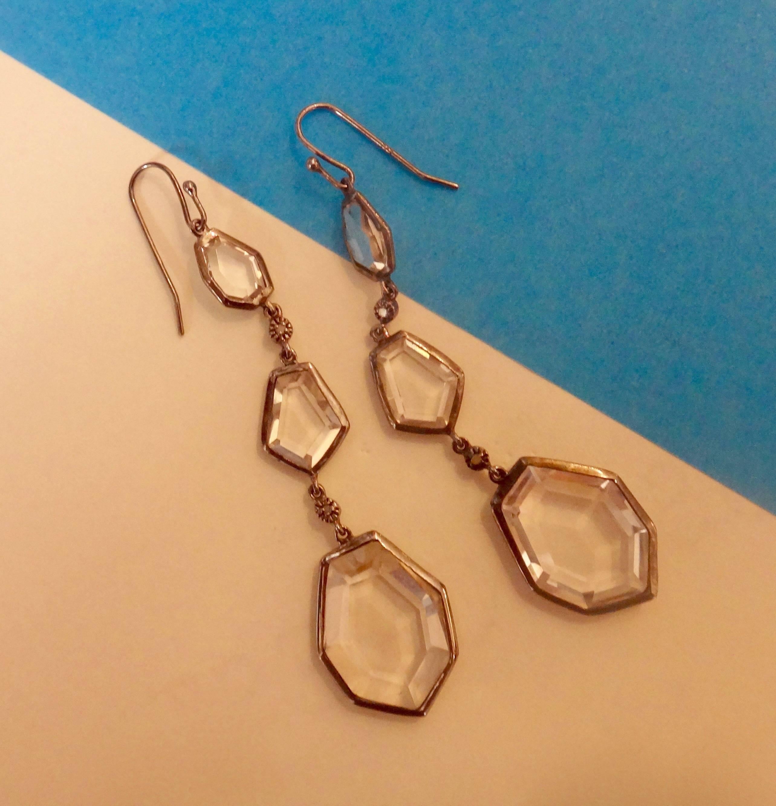 Geometric shapes of sliced and faceted rock crystal are bezel set in blackened sterling silver.  These lightweight, dramatic dangle earrings are so easy to wear both daytime and evening.  