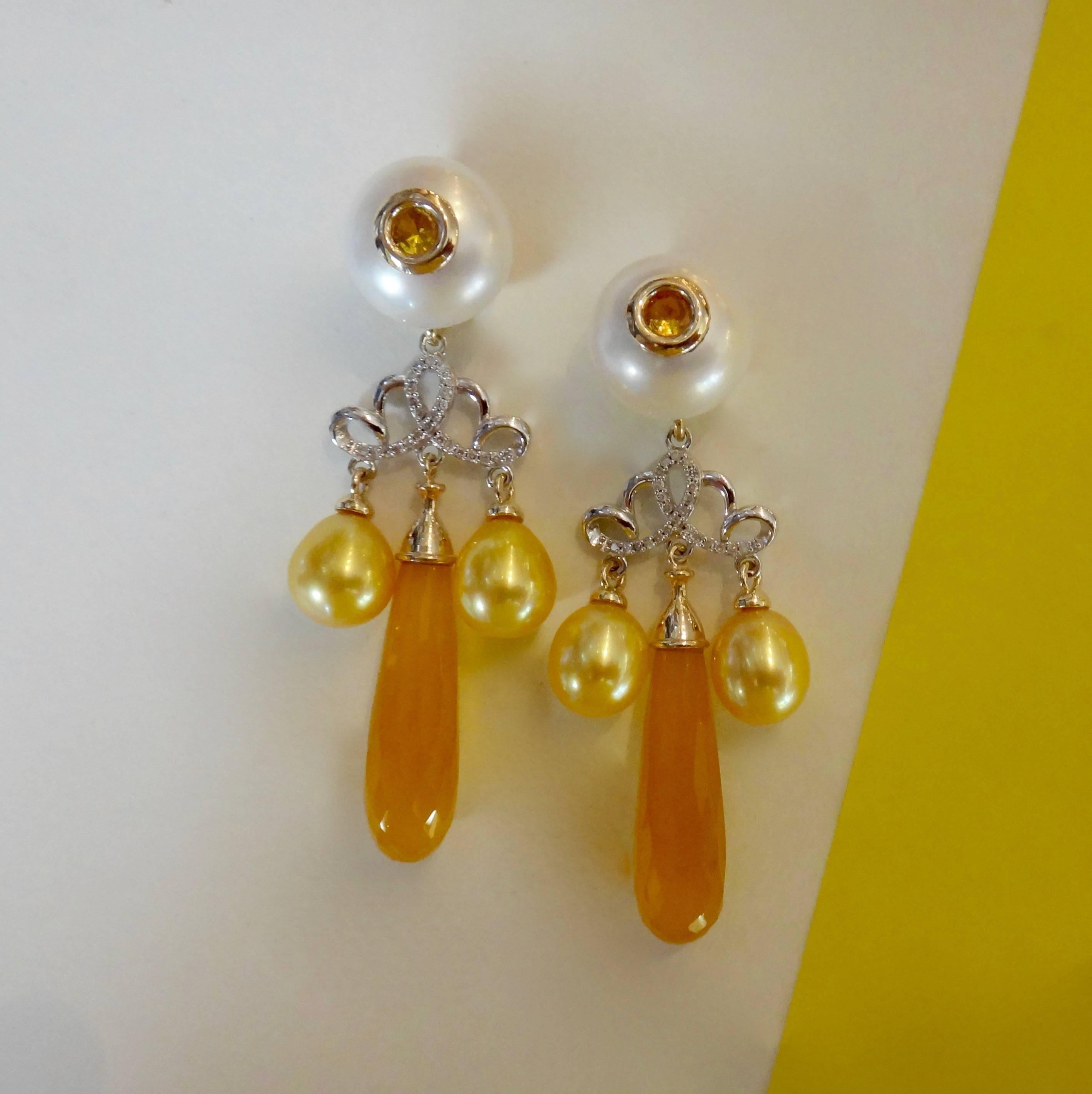 Golden chalcedony briolette in a rich yellow/orange color dangle from white button pearls that are drilled and set with bezeled yellow sapphires.  Gold drop shaped pearls further decorate these two tone, micro-pave diamond dangle earrings.  Post