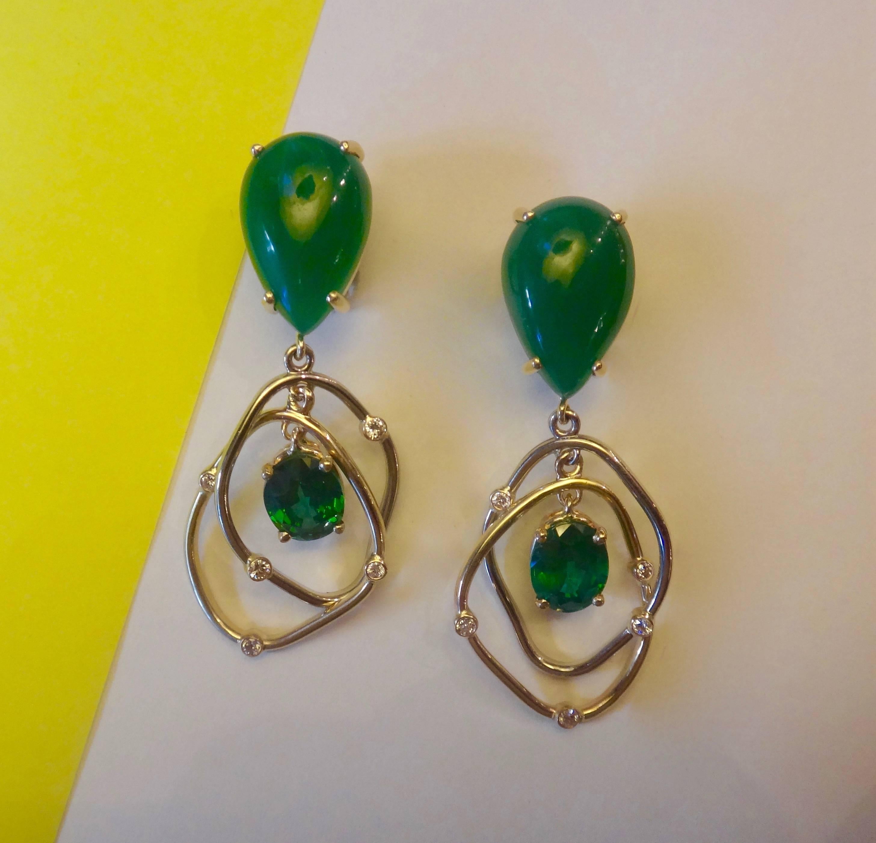 Pear shaped and cabochon cut Botswana agates form the tops of these kinetic earrings.  Dangling below are free form hoops of white and yellow gold interspersed with bezel set diamonds and framing a pair of oval cut green topaz.  The one-of-a-kind