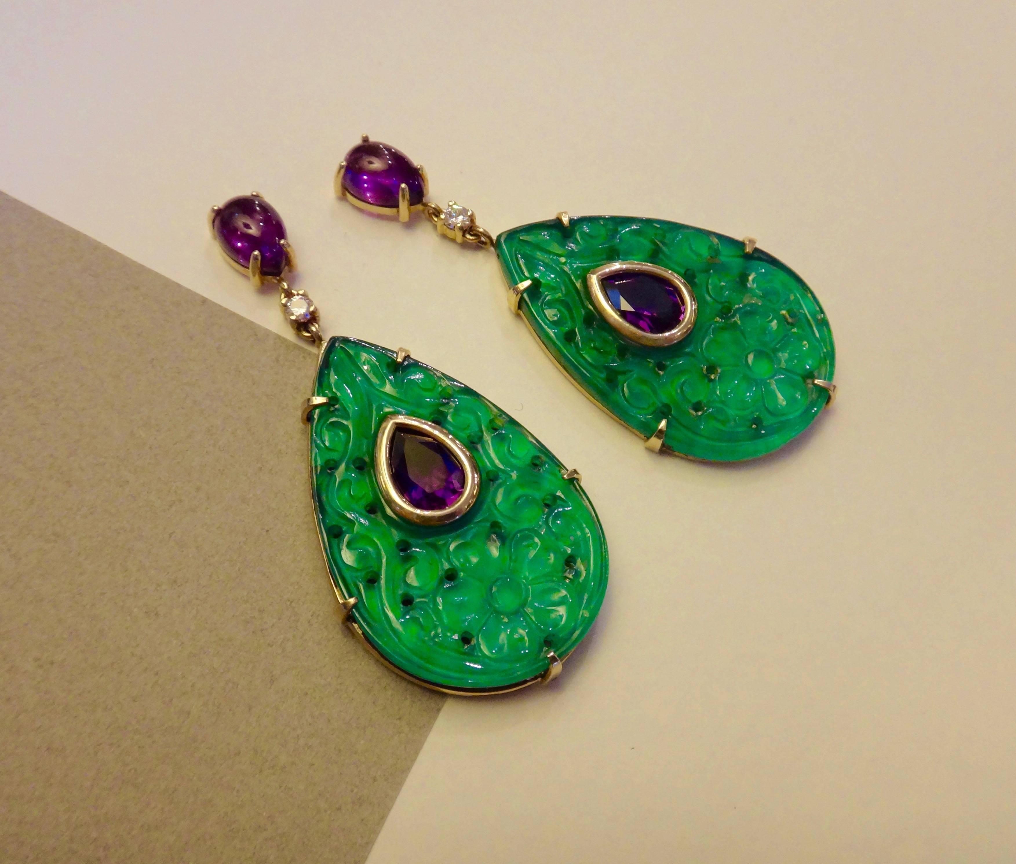 Plaques of carved green agate form the foundations for these dramatic dangle earrings.  Embellishing the plaques are faceted and cabochon cut amethysts along with brilliant cut diamonds.  All in handmade 18k yellow gold settings.  Post and jumbo