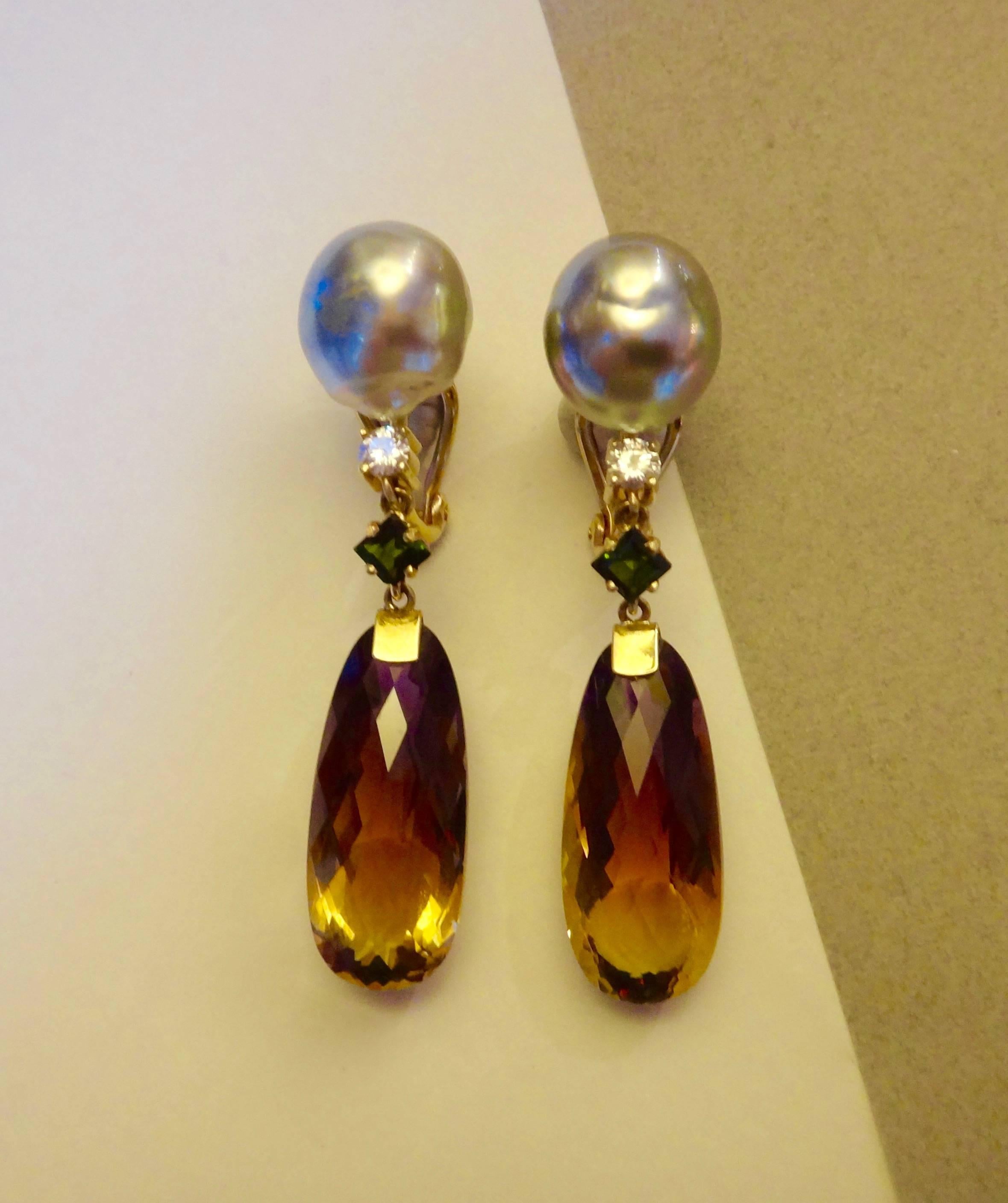 Ametrine briolettes graduating in color from purple to golden yellow are the featured elements in this dangle earrings.  Further embellishing the earrings are square cut green tourmalines, brilliant cut diamonds and baroque Tahitian pearls of a