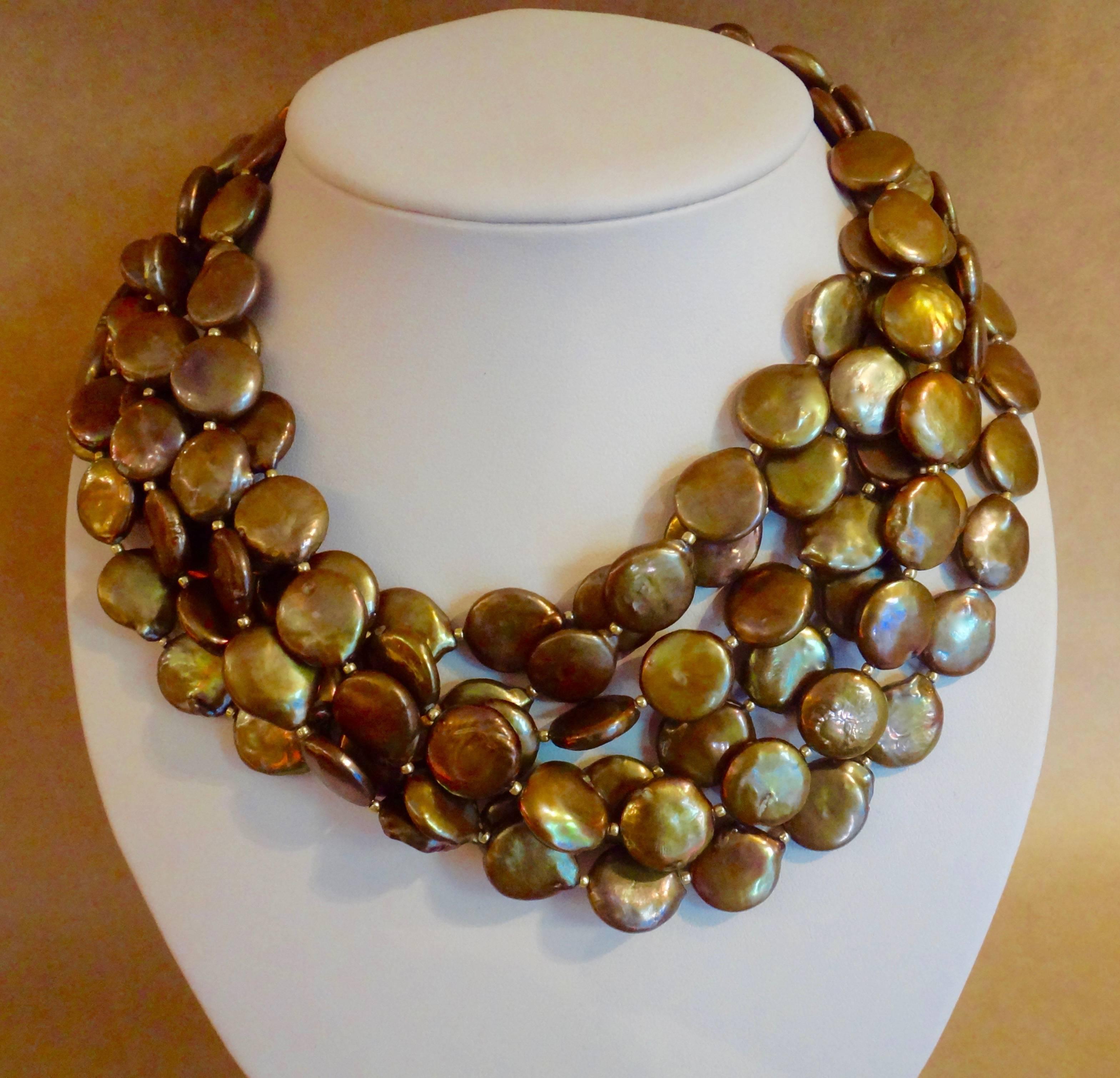 Six strands of richly colored bronze pearls comprise this torsade style necklace.  The pearls are spaced with tiny gold beads and the necklace is finished with a hammered vermeil hook and eye clasp.  The necklace is 18 inches long but may be