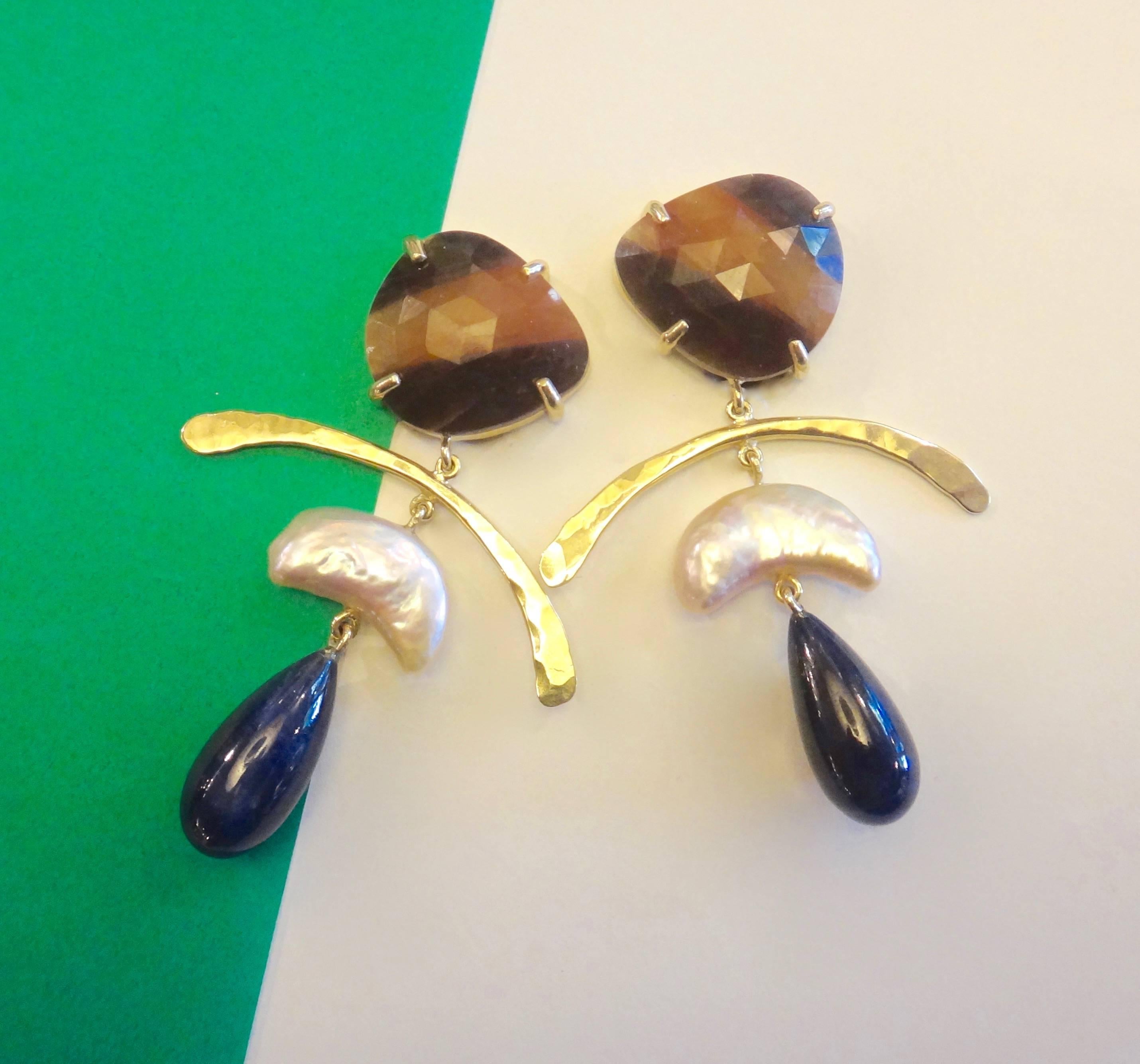 Faceted sapphire with bands of chocolate brown and gold are combined with  half moon shaped cultured pearls and blue sapphire drops in this mobile earrings.  All are set in fabricated and forged 18k yellow gold.  Posts with omega clip backs.  