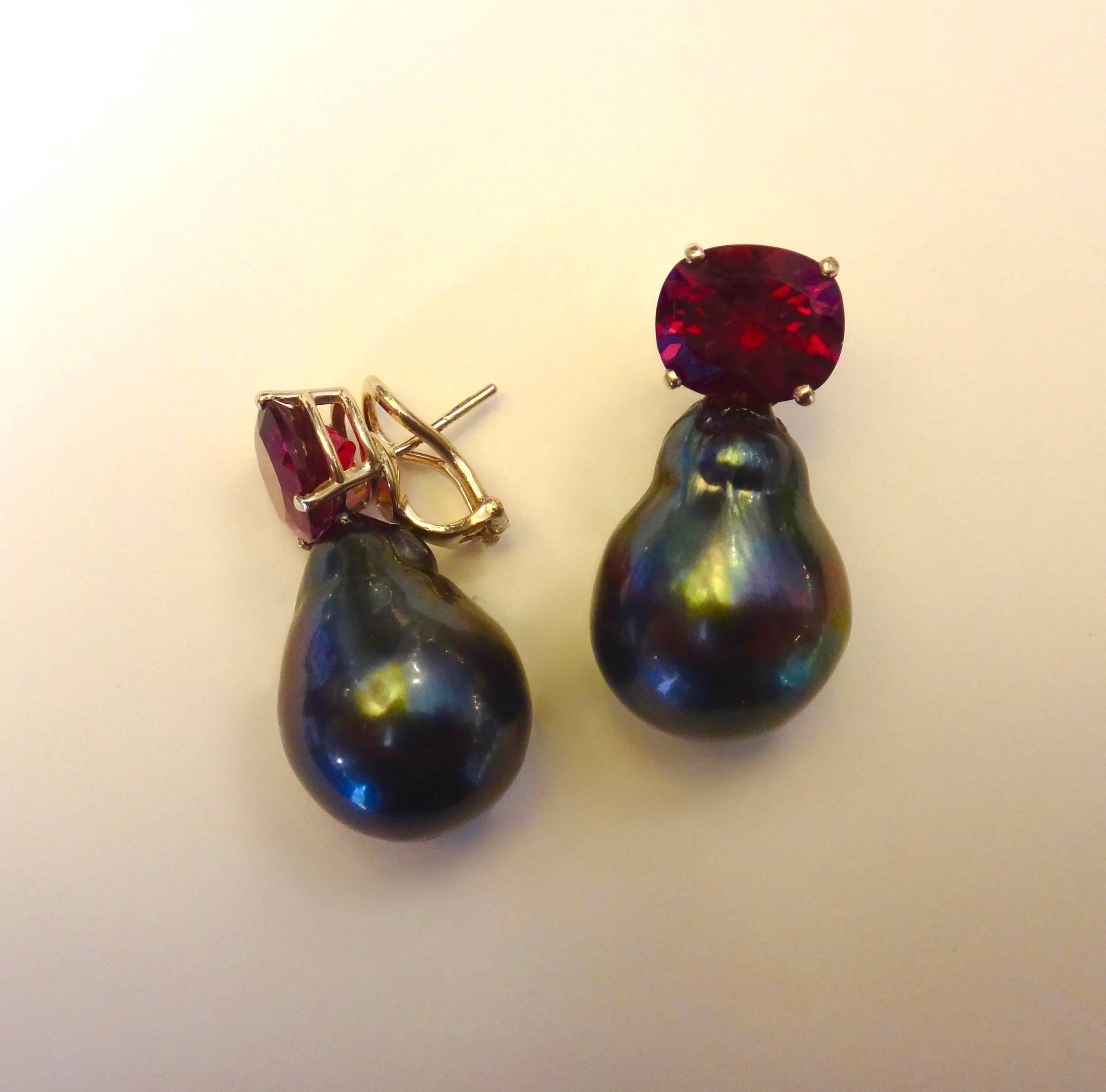  Faceted, cushion shaped and perfectly matched rubelites (red tourmaline) of the finest color and quality are paired with huge, baroque Tahitian pearls in these 