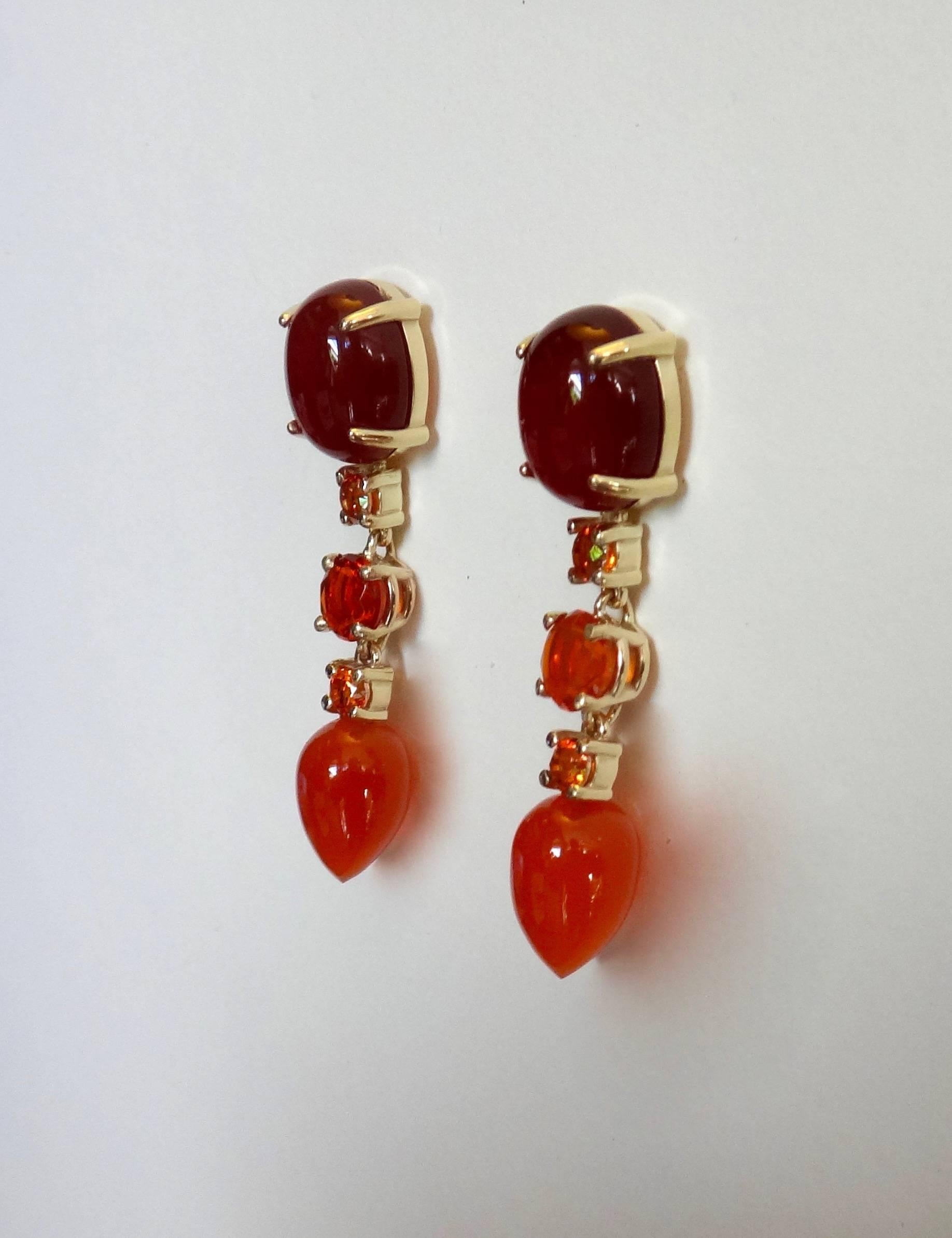 Cabochon cut carnelian, faceted orange topaz, orange Mexican fire opal and a new shape of briolette called an 