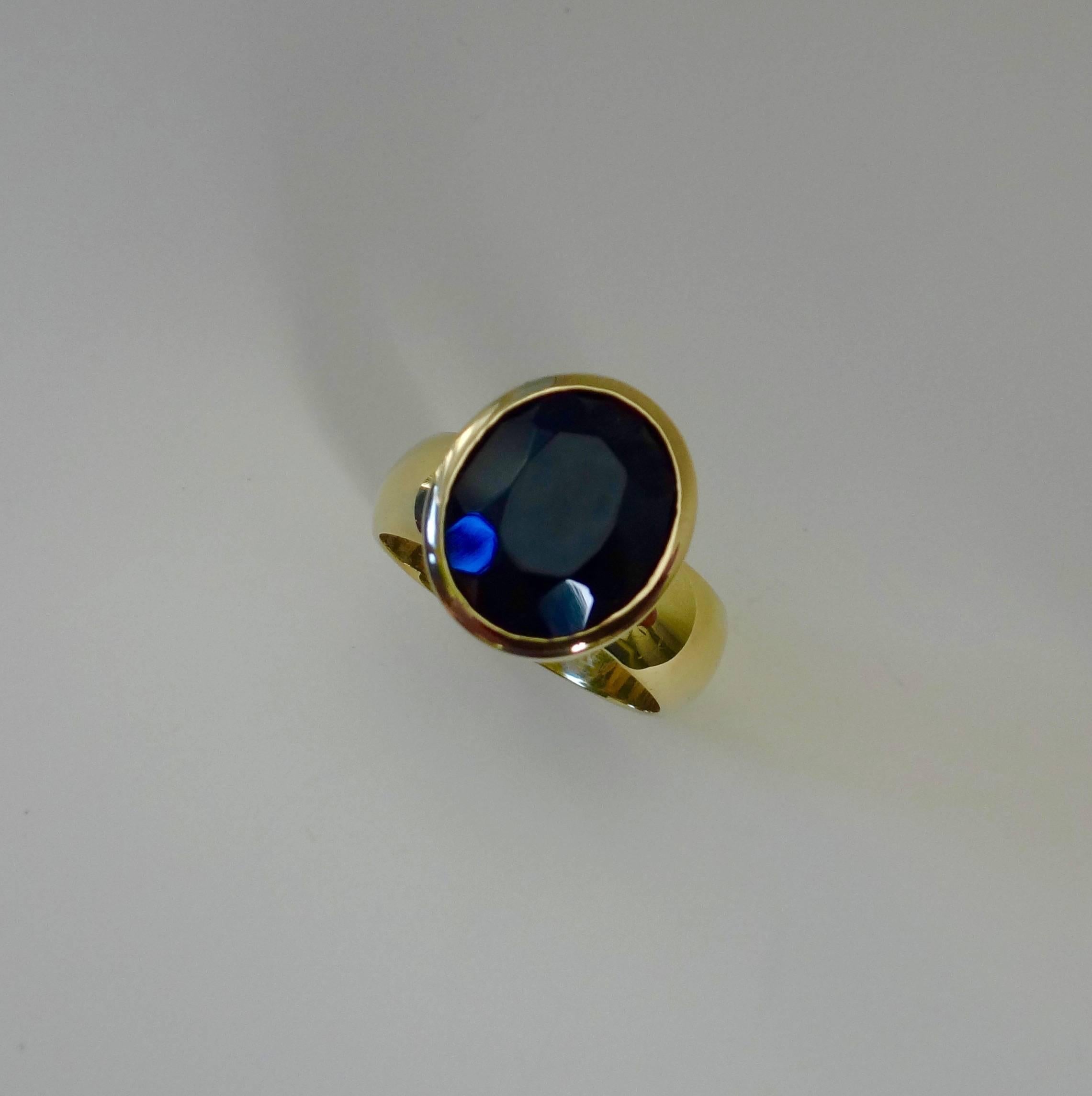 A faceted and oval shaped black spinel is bezel set in this 18k yellow gold Leah ring.  The beaded detail around the bezel adds interest.  Leah rings look lovely all by themselves but are dramatic stacked together in different colors and shapes. 