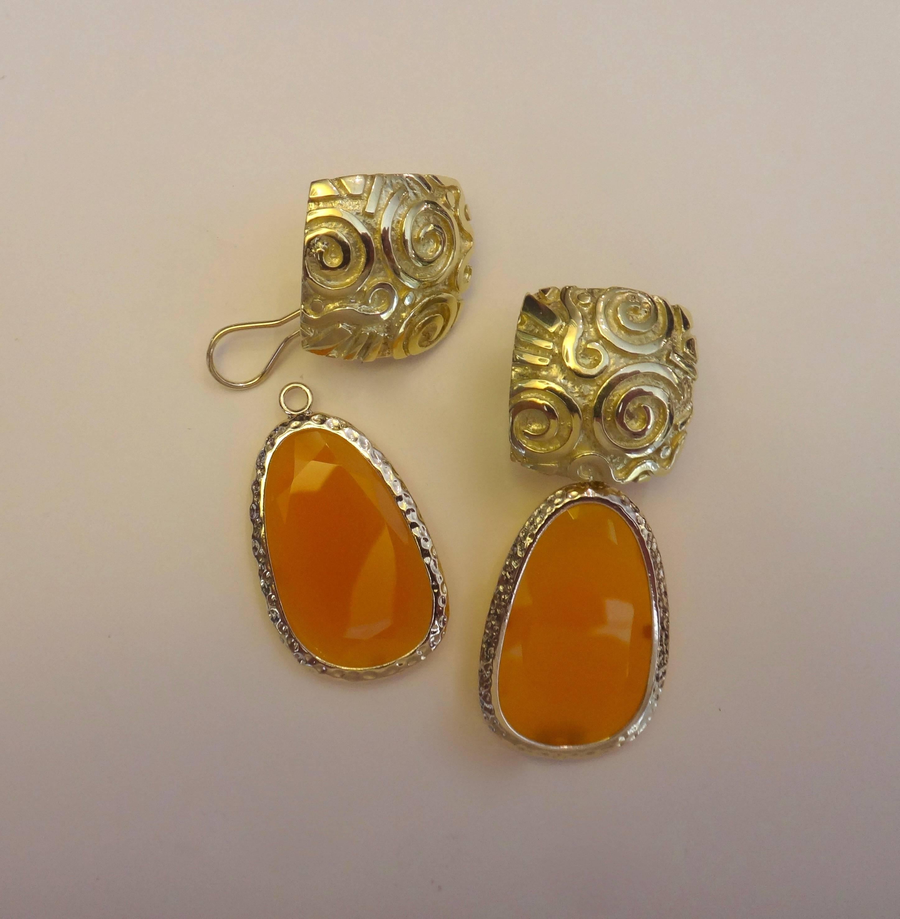 Michael Kneebone's "Go To" 18k yellow gold Petroglyph earrings are decorated with removable faceted slices of yellow chalcedony.  The spirals and squiggles  were inspired by the cave painting done by Native Americans of the great