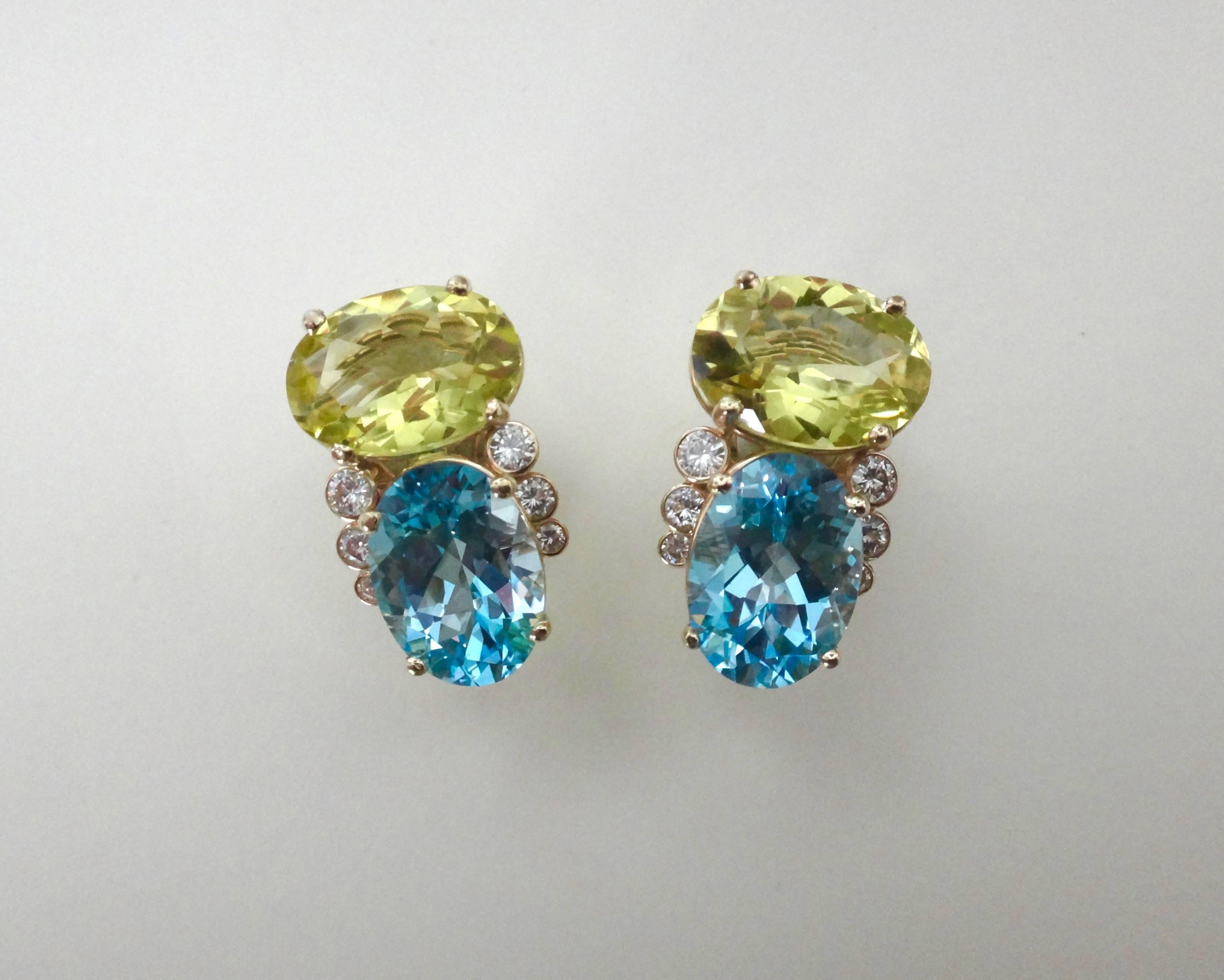 "Due Pietra" earrings consisting of oval cut lemon citrines blending harmoniously with oval cut baby blue topaz.  The prong set gems are complimented with bezel set white diamonds.  The substantial earrings have posts with omega clip backs