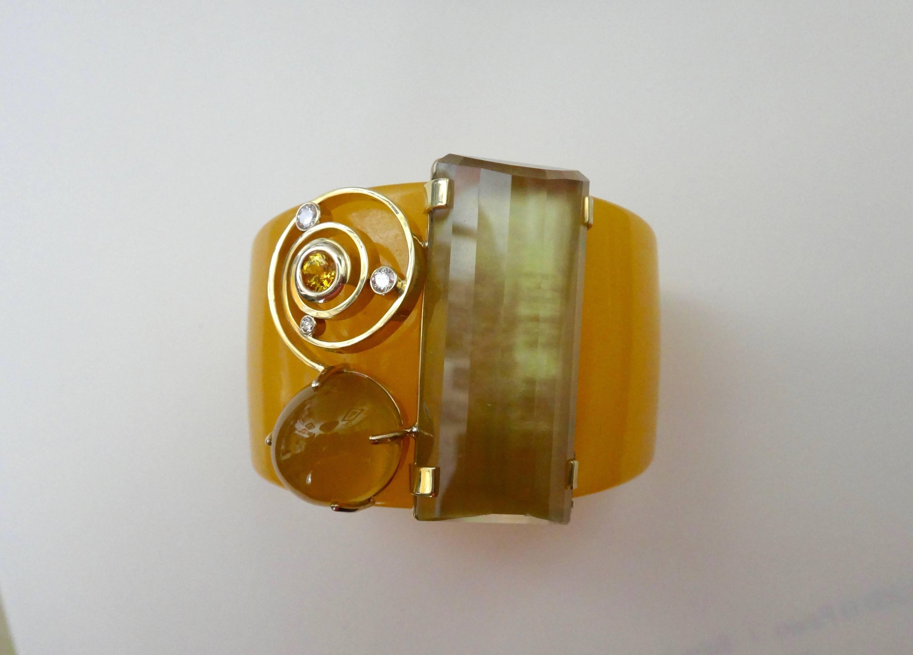 A  Bakelite cuff forms the foundation for this one-of-a-kind bracelet.  The composition consists of a large citrine masterfully cut by Jerry Newman, Botswana agate, yellow sapphire and diamonds.  The golden cluster of gems are set in 18k yellow