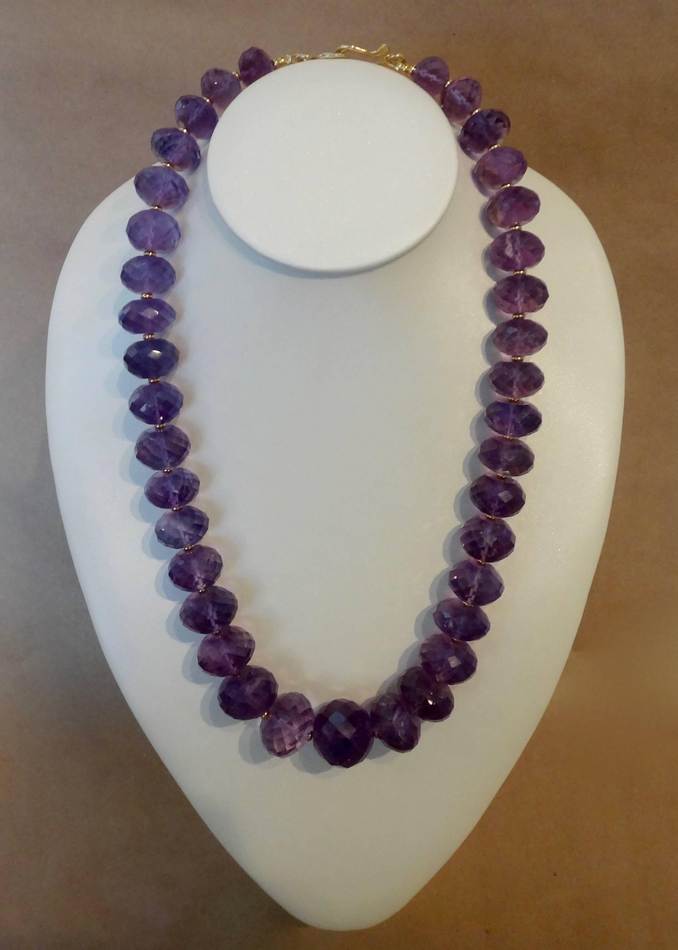 37 rondelle shaped and faceted beads comprise this amethyst necklace.  The graduated beads range in size from 13mm to 22mm.  There are small gold beads between the amethyst beads which adds depth and versatility.   The piece is finished with a