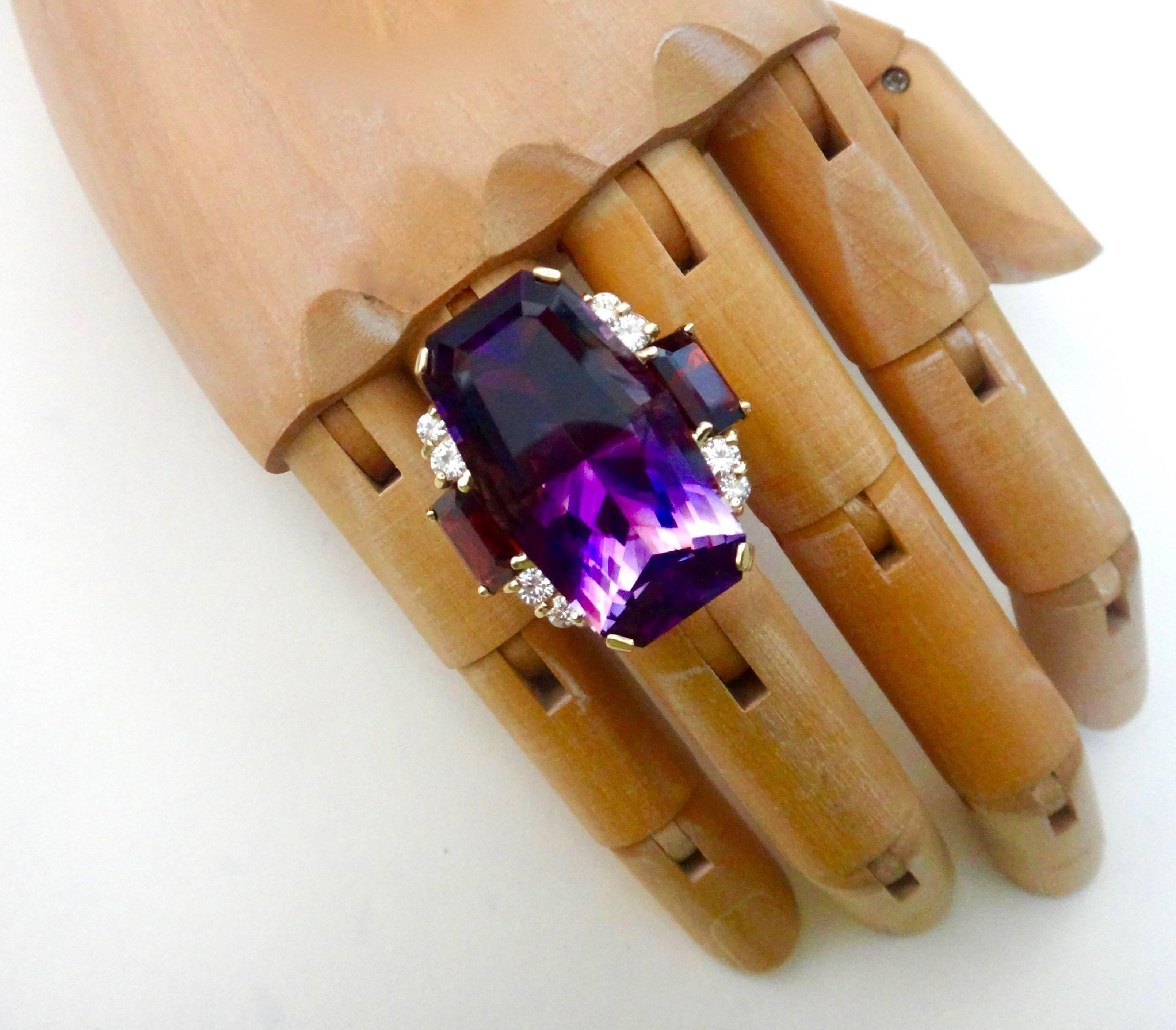 A dramatic ten sided amethyst by master gem cutter Jerry Newman is featured in this bold cocktail ring.  This is a perfect example of how important the cut is in a finished gem.  The amethyst is heavily zoned (bands of dark and light color) typical