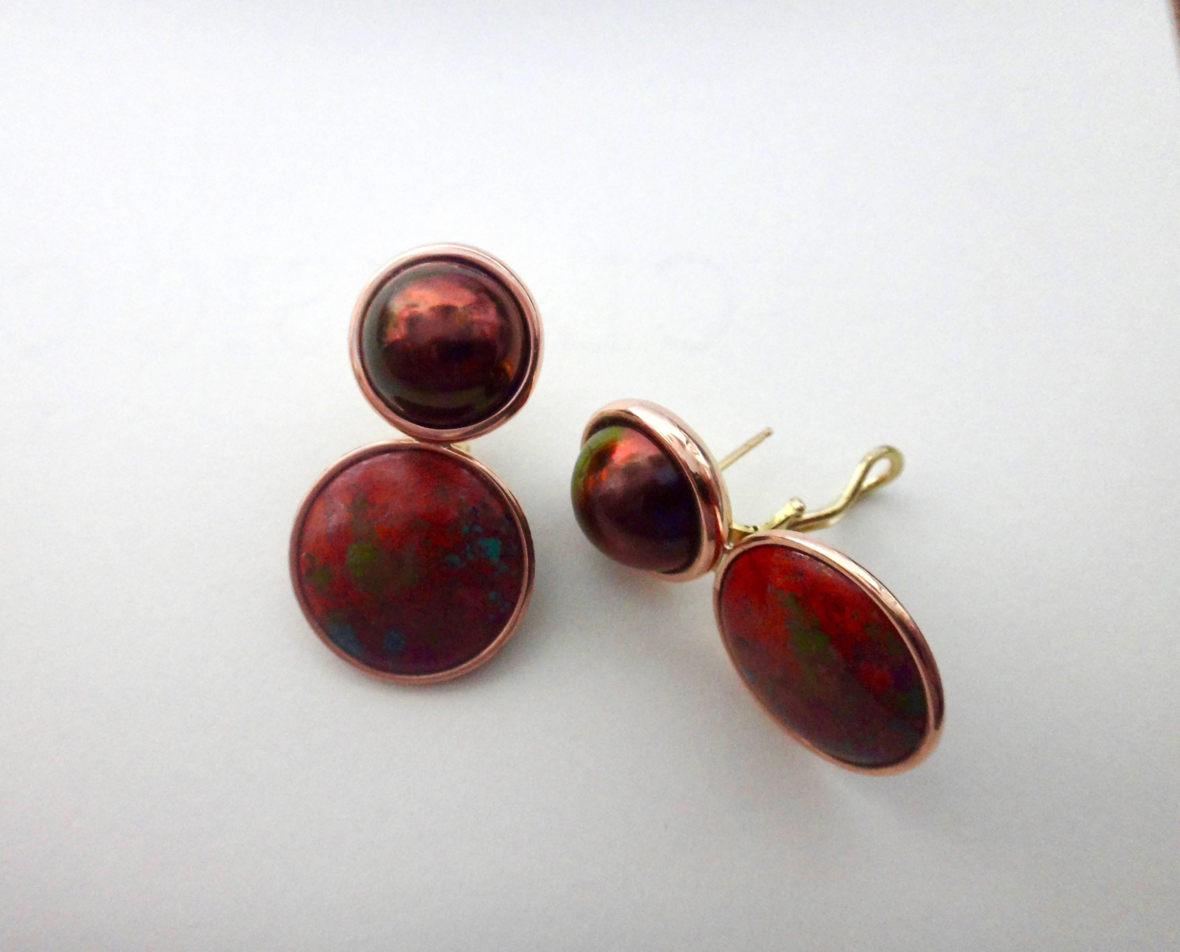 A luminous pair of bronze colored mobe pearls compliment a highly unusual pair of book matched red jasper (an aggregate of microgranular quartz and/or chalcedony and other minerals). The gems in these bold earrings are set in fabricated pink gold