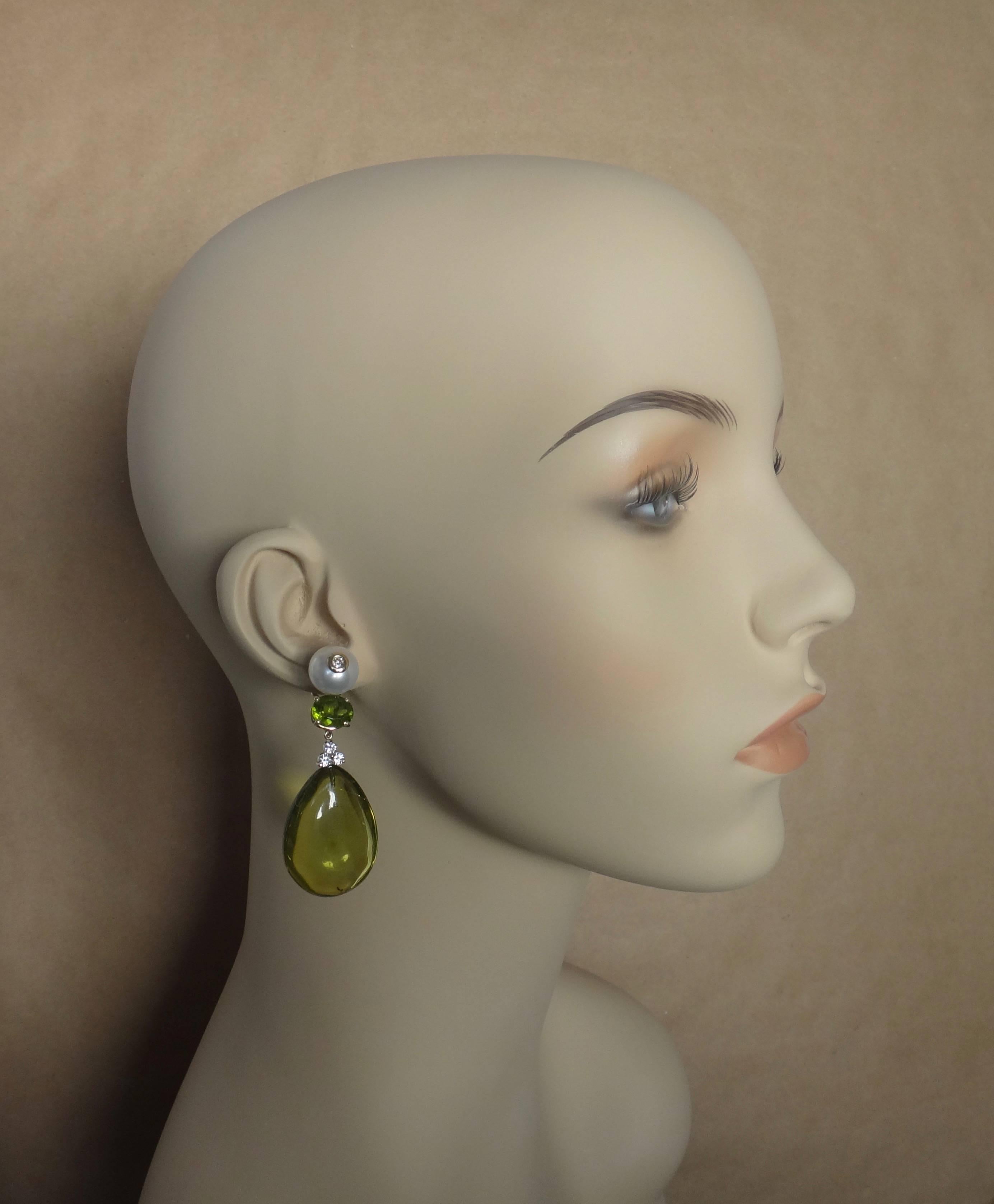Green Amber from the Dominican Republic is featured in these dangle earrings.  (The Dominican Republic is the only island in the Caribbean where amber has been discovered and is mined. Dominican amber is found in a range of colors, among them