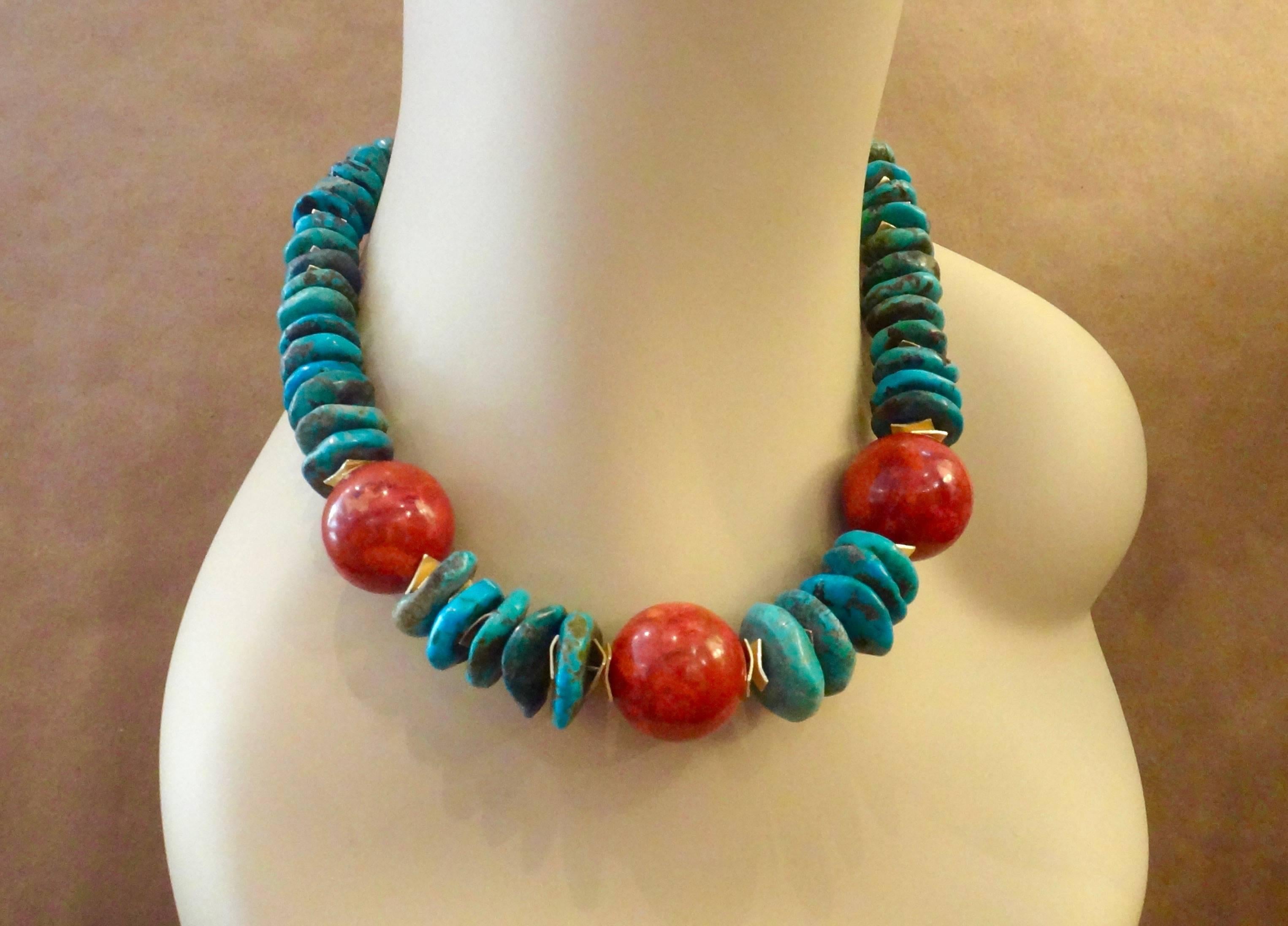 Three tomato red beads of fossil coral are combined with turquoise nuggets in this daring and dramatic necklace.  The beads are spaced with cornflake shaped rondelles in vermeil as is the hook and eye clasp.  The necklace measures 18 inches long.