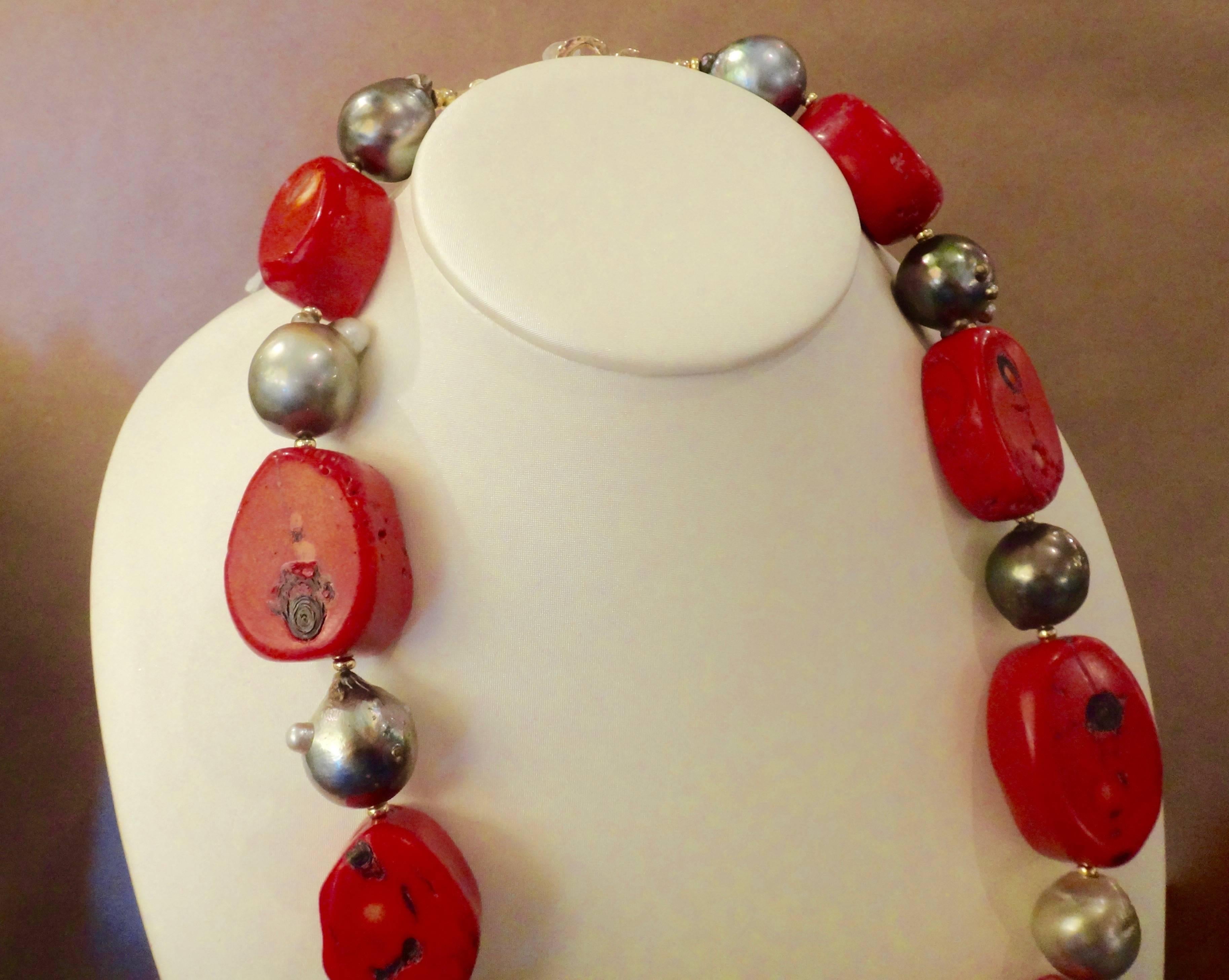 Huge slices of tomato red coral are interspersed with 17mm (plus) baroque Tahitian pearls in this bold necklace.  The coral has natural dark inclusions which play off and compliment the pearls.  There are a range of gray tones from light to dark in