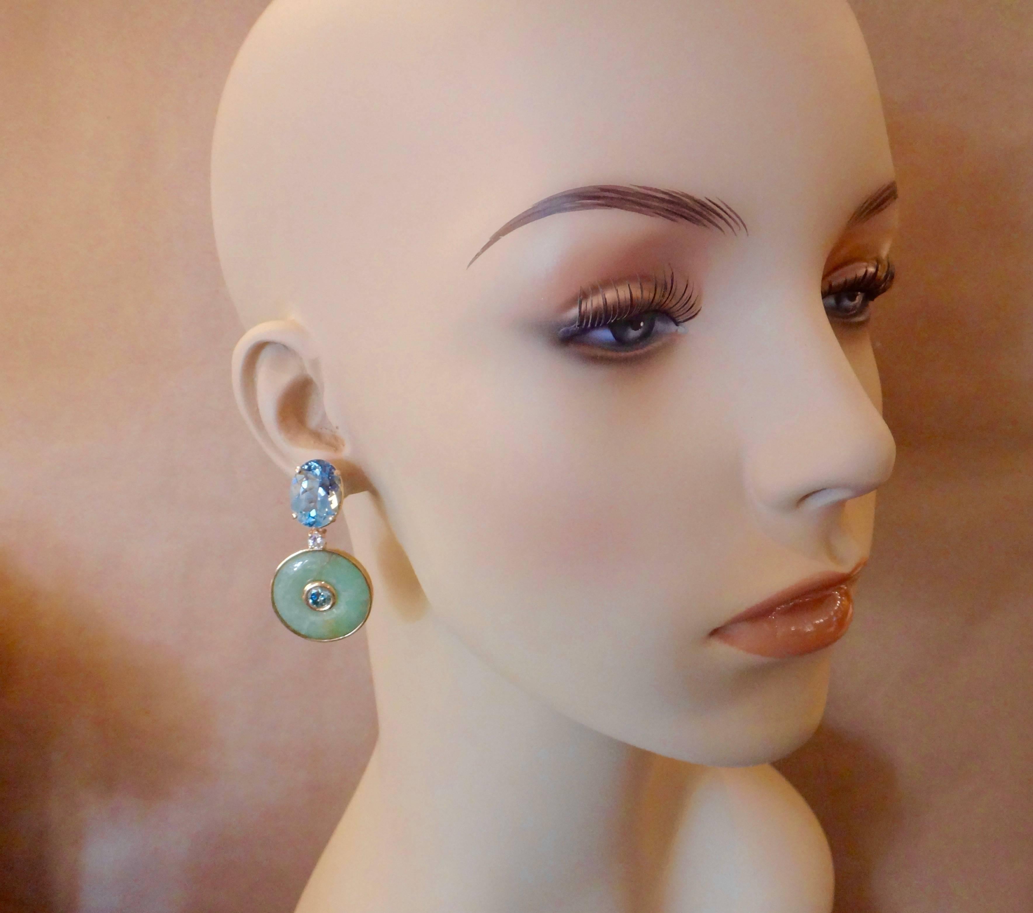Carved discs of antique green Burmese Jadeite are the centerpiece of these dangle earrings.  (In Chinese, jade is known as 
