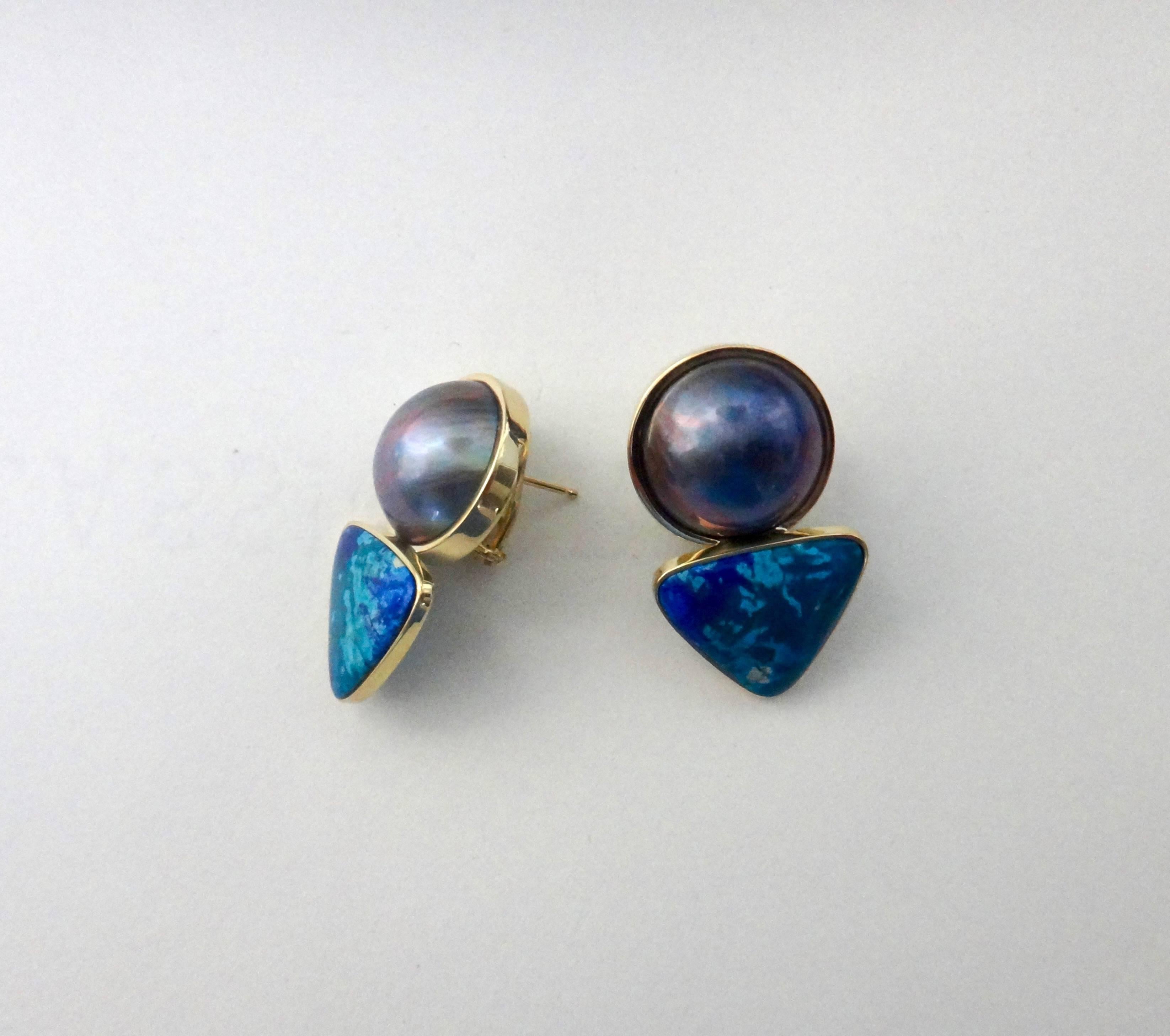 Huge (18mm) gray mabe pearls reflecting a rainbow of colors are paired with triangle shaped cabochons of azurite in chrysocolla in these daring drop earrings.  The gems are set in handmade 18k yellow gold mountings and come with posts and omega clip
