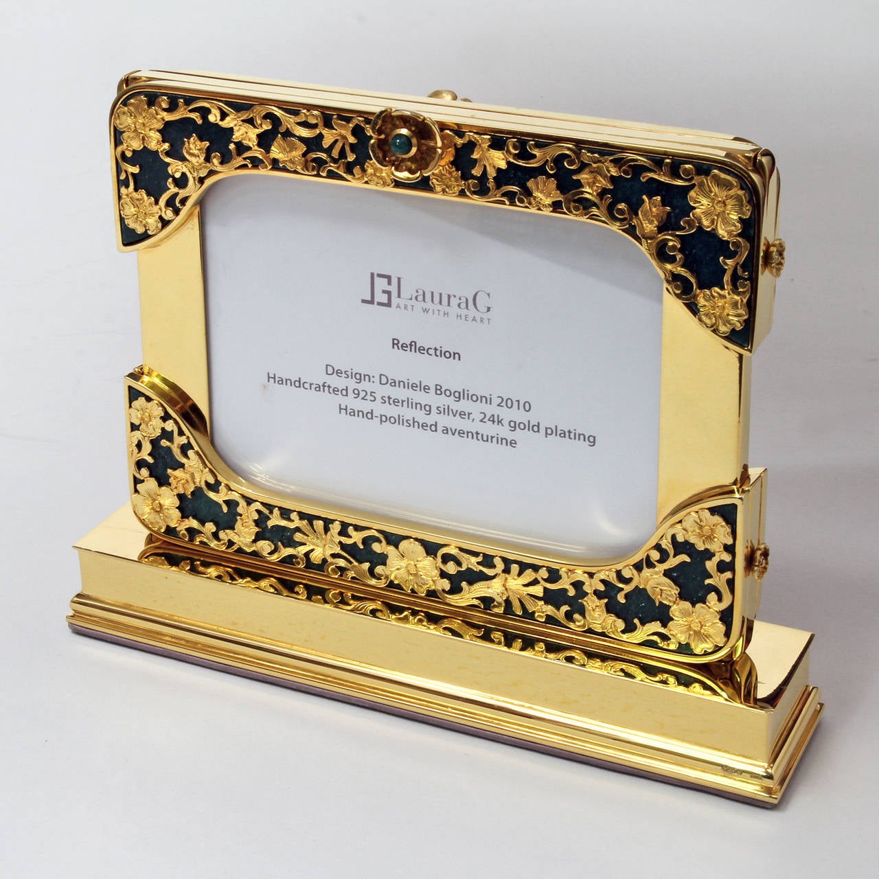 Reflection is tha name of this gorgeous photo frame signed Laura G Art with heart. It is handcrafted  in 925 sterling  silver gold plated  24 k and it is the oldest piece of the collection Art with Heart ,Delicately formed floral shapes branch out a