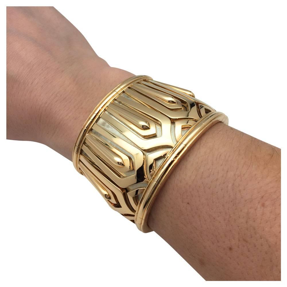 A two gold semi-rigid bracelet by Cartier, "Pharaon" collection, figuring a yellow gold 750/000 geometrical motif on a matted white gold 750/000 background.
Ancient-Egypt inspiration, circa 1990.
Width: 47 mm.
Inside diameter : 57 mm
Net